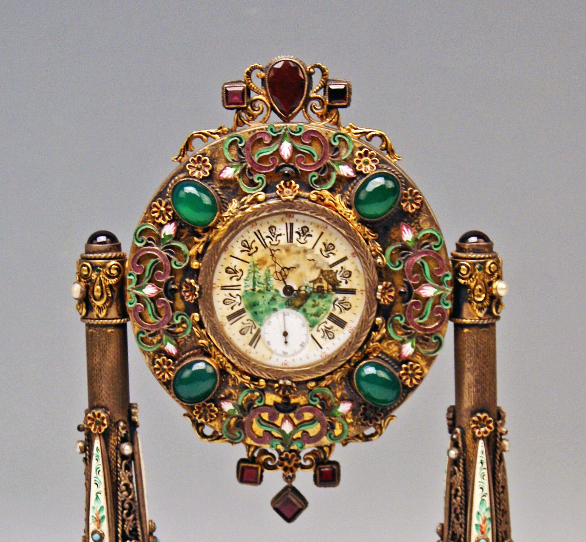 Stunning Viennese enamel vintage table clock - made of:
-- silver 
-- nacre
-- enamel (excellently chiselled)
-- onyx 
-- semiprecious stones 
Attention: The table clock is partially gilt !

Manufactured circa 1870

Table clock based on