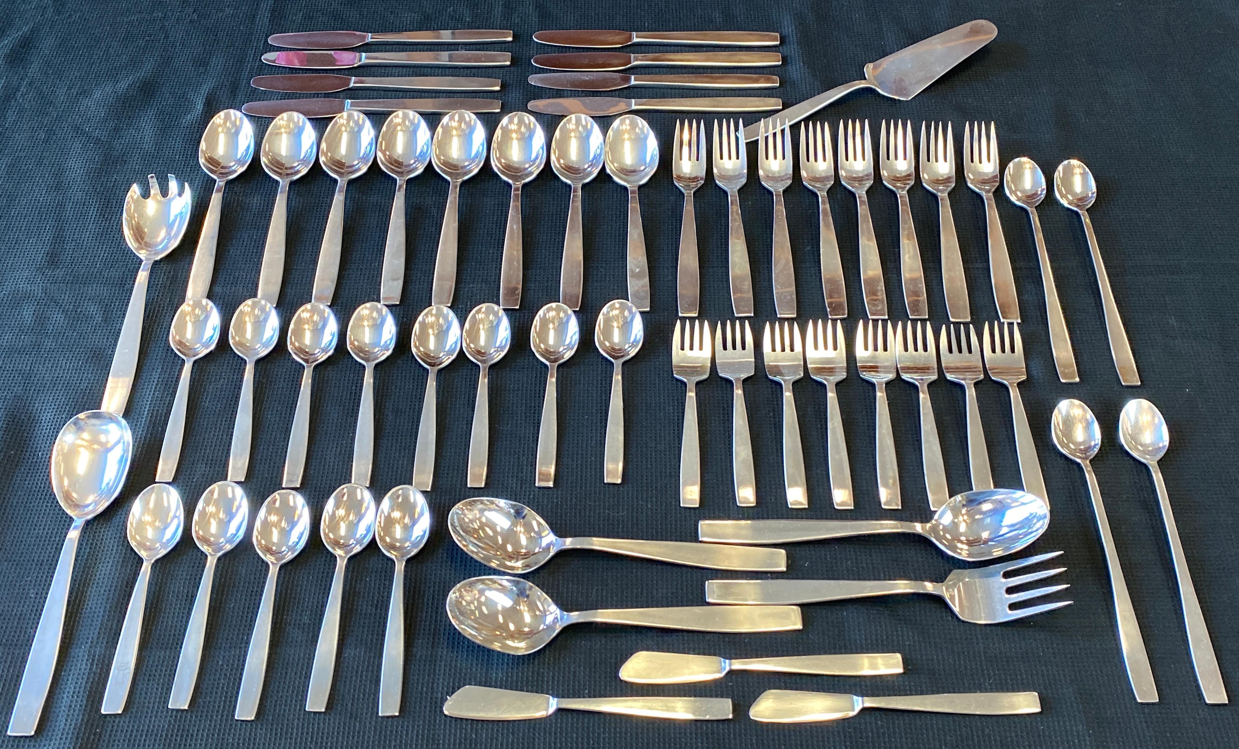 Offered here is a 59 piece set of “Vienna Modern” flatware Design by Helmut Adler for Amboss Austria
8 place settings, plus serving spoon, serving fork, salad tongs, cake server, 3 butter knives and 4 ice tea spoons

8 soup spoons, 7 1/2 inches