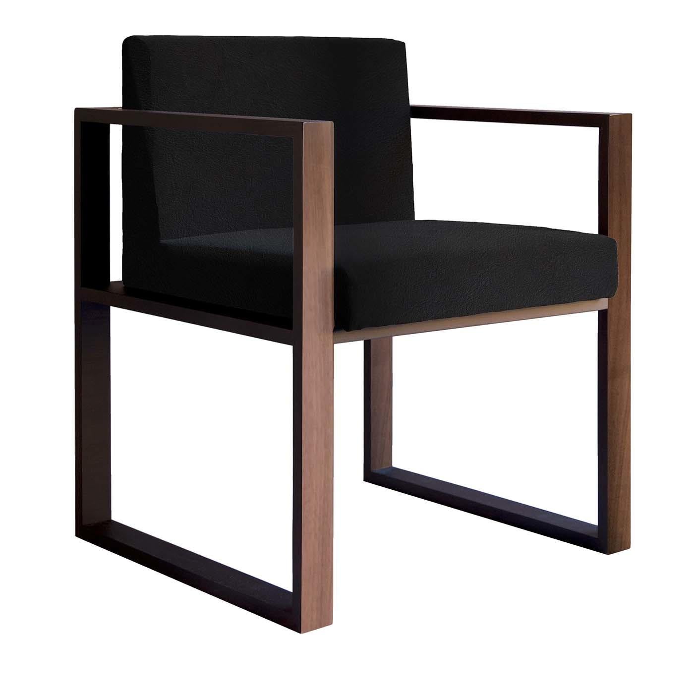 A clean and contemporary design characterize the stylish Vienna NL1 Chair featuring a structure in Canaletto Walnut wood. Providing exceptional comfort are the padded seat and back, luxuriously upholstered in black full-grain leather. With its