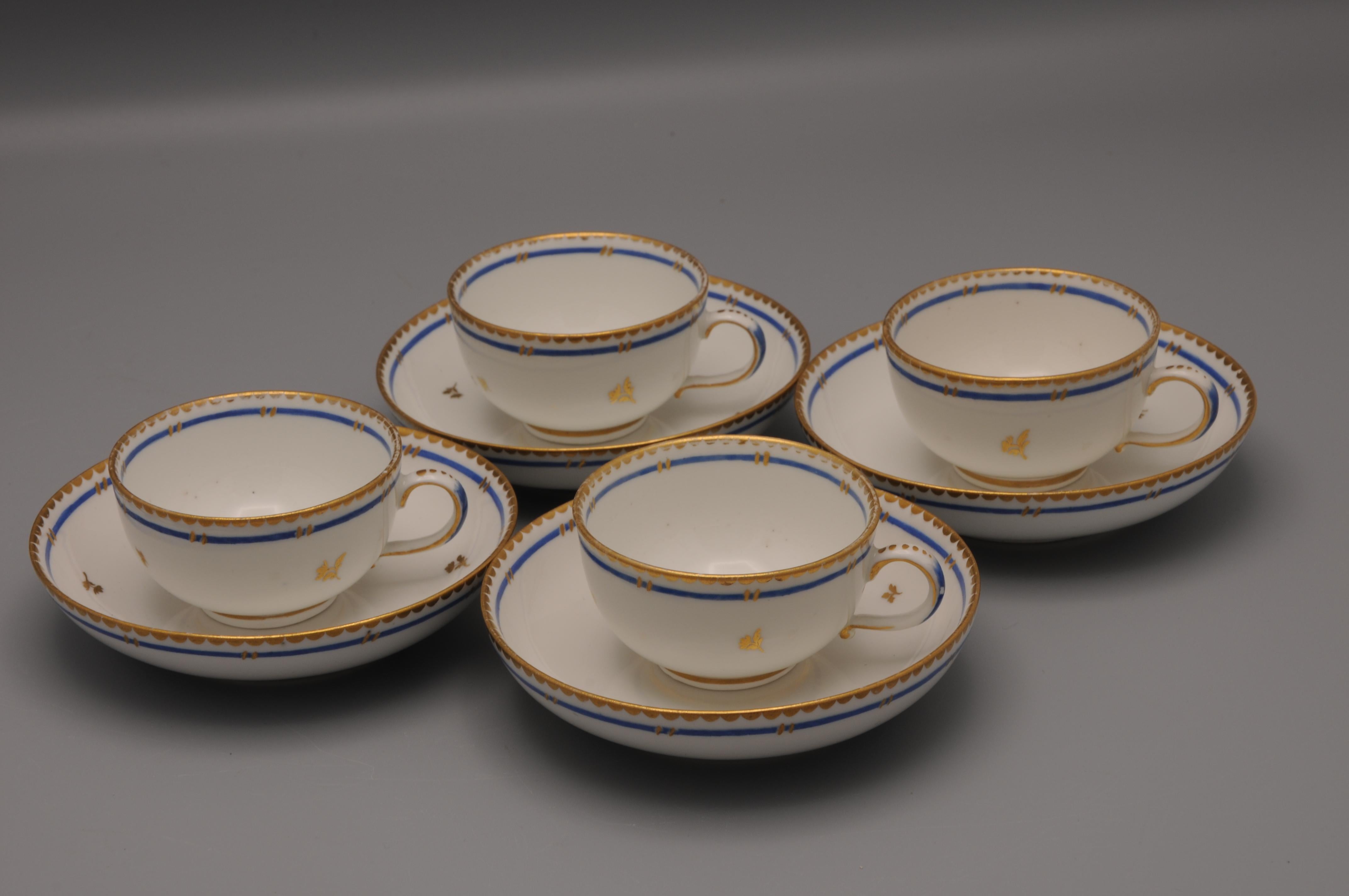 Set of 4 cups and saucers with decoration of gilt flower sprays and blue border by the Kaiserlich priviglierte Porzellan Fabrique in Vienna. It was founded in 1718 and continued until 1864.

The firm was Europe's second-oldest porcelain factory