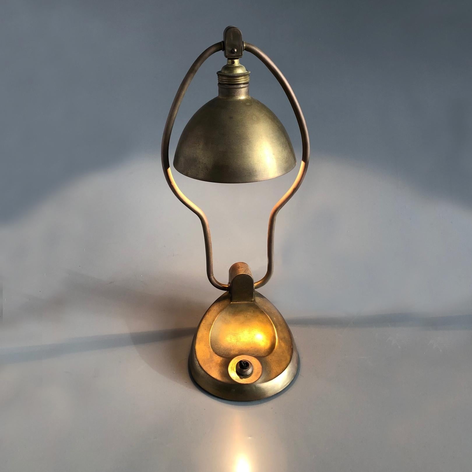 Table lamp made of cast brass base, bras shade support and spun brass shade. Adjustable reflecting brass shade, fitted with one E 27 socket and base integrated switch. Nice original condition, just cleaned and rewired.