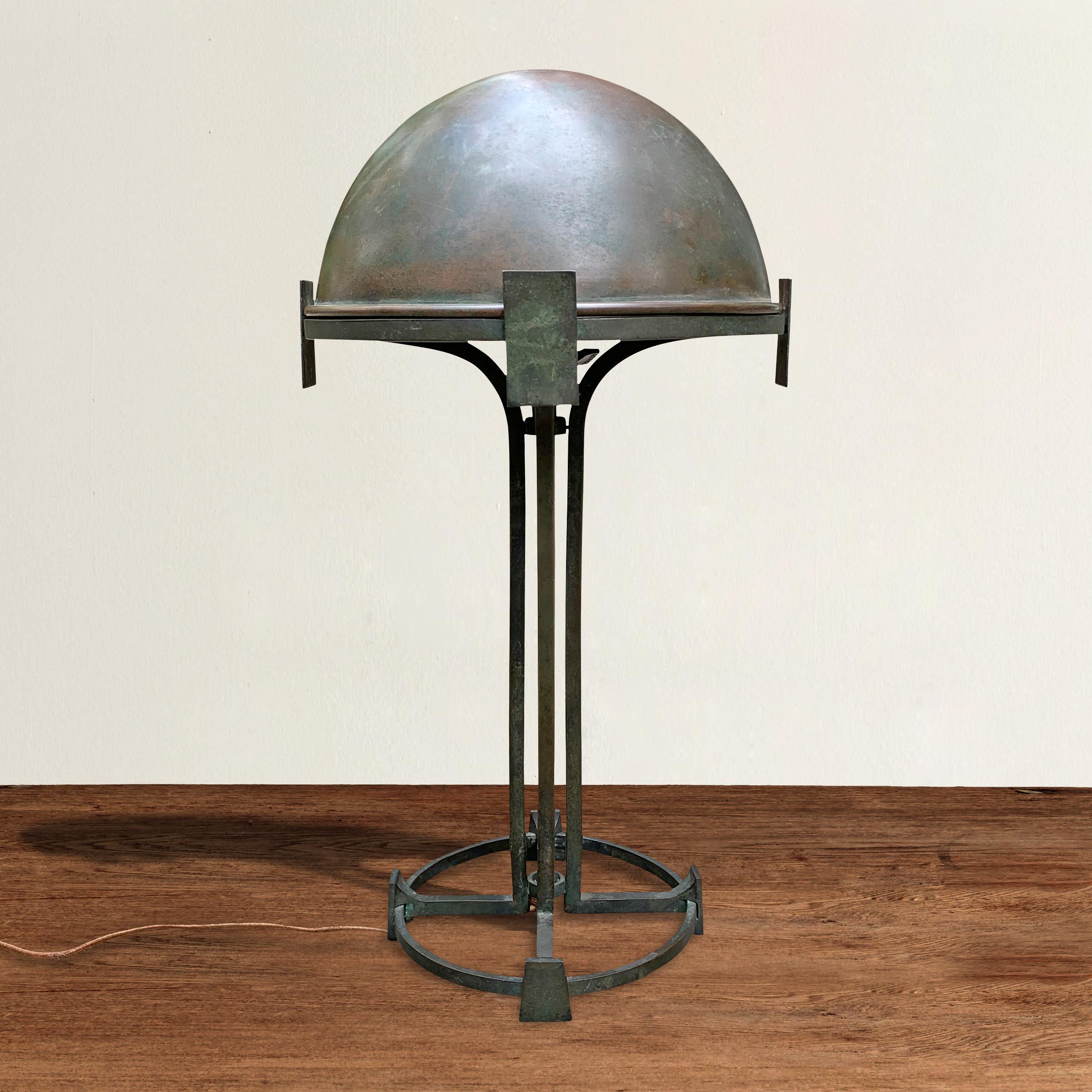 An incredible fine quality early 20th century Vienna secession bronze table lamp with a removable dome shade supported by four square uprights turning into legs with spade-form feet and a circular base. The bronze has patinated beautifully! Marked