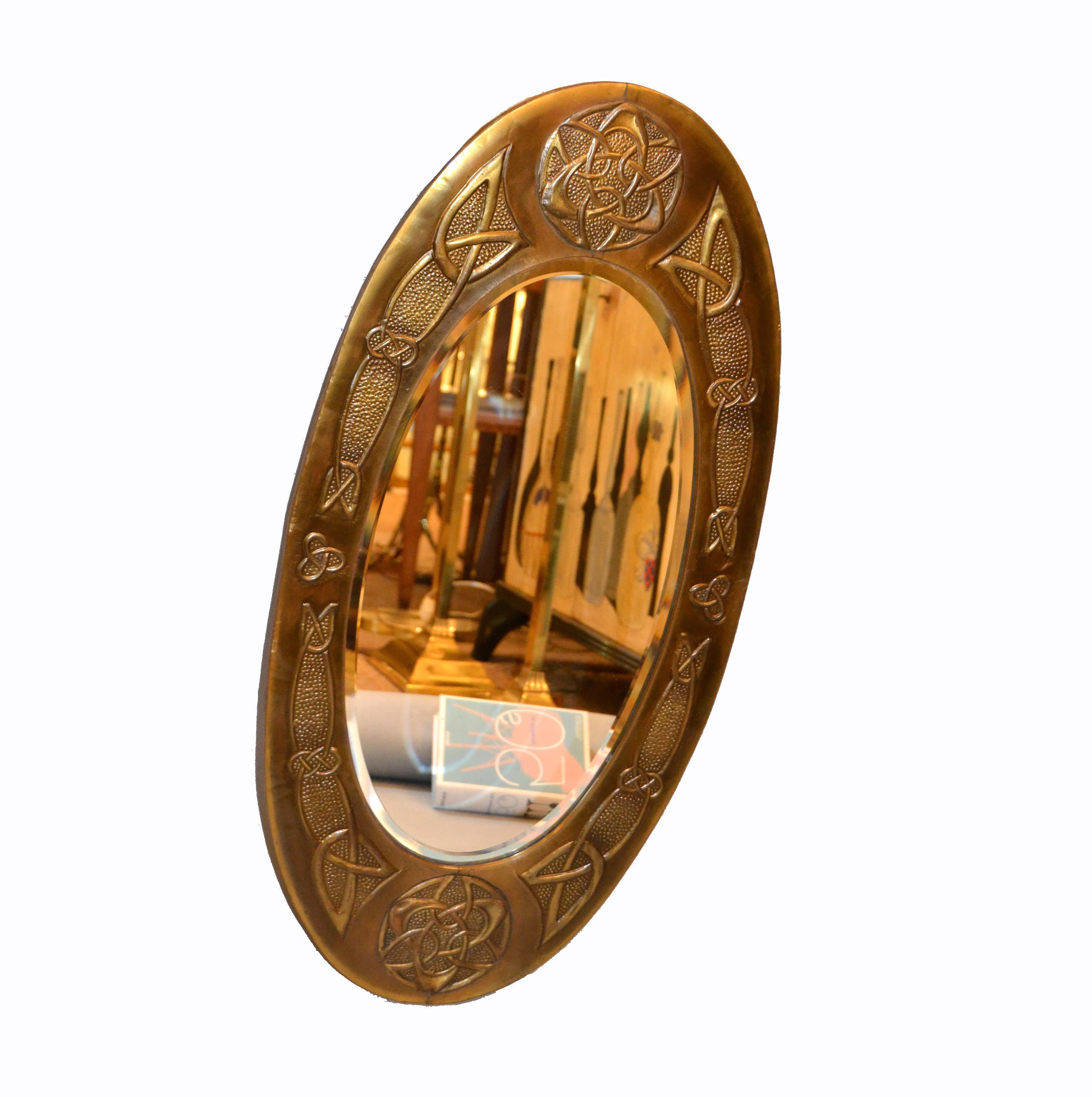 Arts and Crafts oval bronze mirror with detailed Celtic ornamentation and wooden backing.
This Design was made circa 1910 in the UK.
The mirror is beveled.
