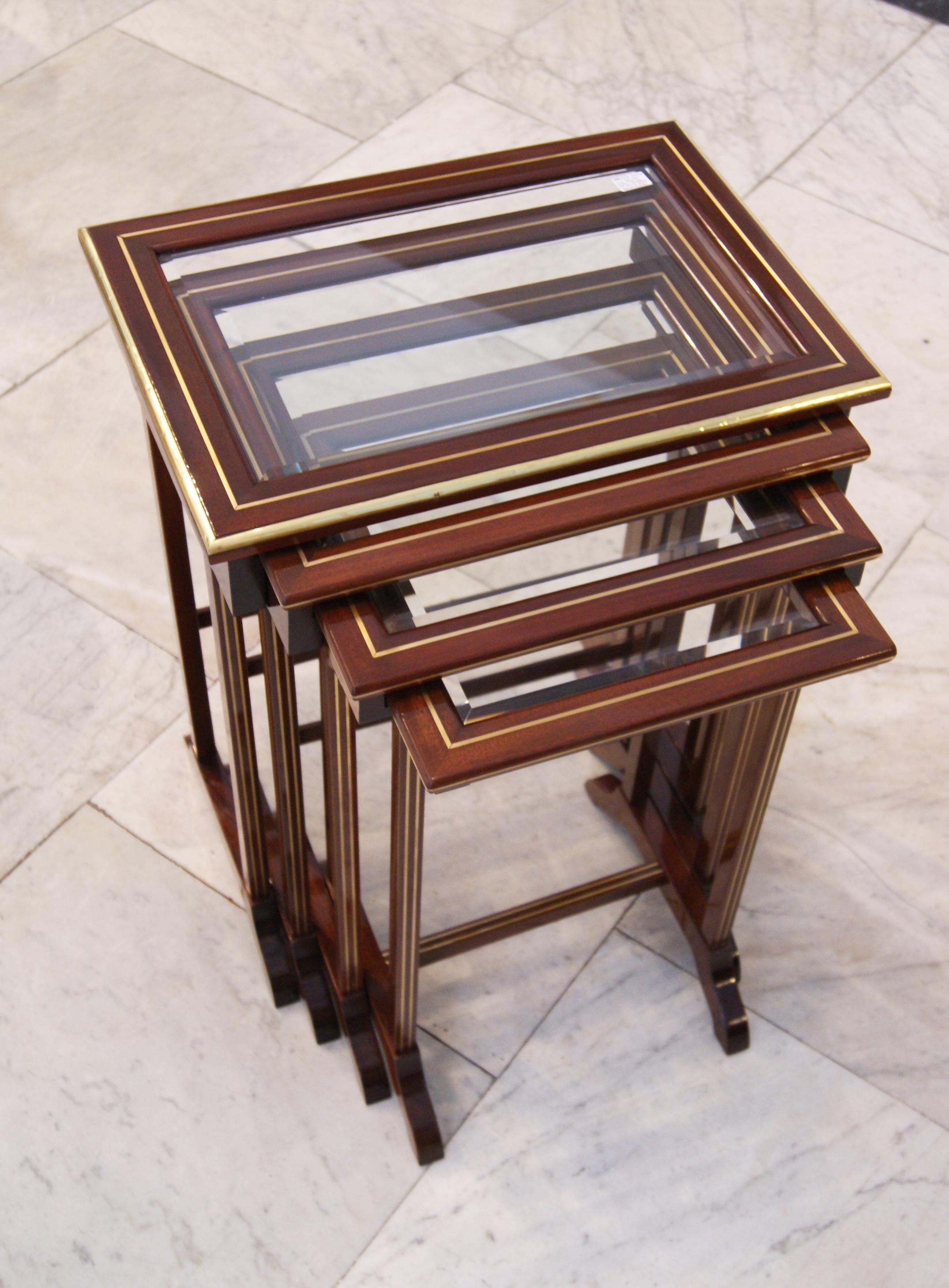 Set of four side tables, Art Nouveau, circa 1900

High quality handwork / beechwood / dark mahogany stained / hand polished
four nesting side tables in different sizes from elegant form type. Each of the tables has a faceted glass plate on top. A