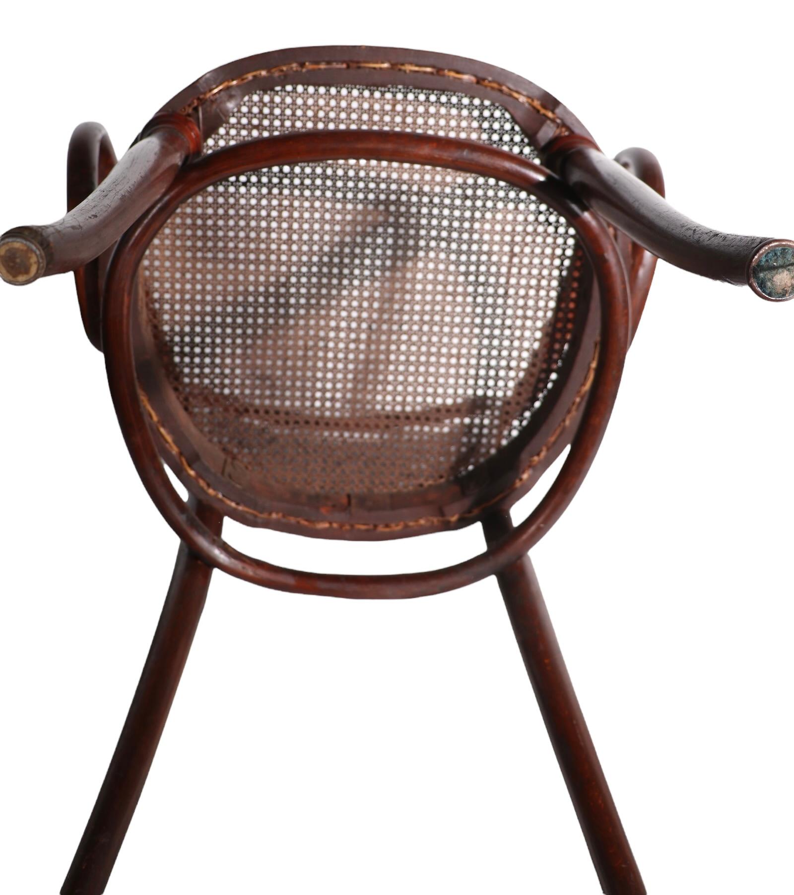 Period Vienna Secessionist bentwood armchair, attributed to J&J Kohn in the style of Thonet, and Fischel. The chair is in very fine condition, clean and ready ton use, we have had the canning professionally replaced. Early Modernist design still