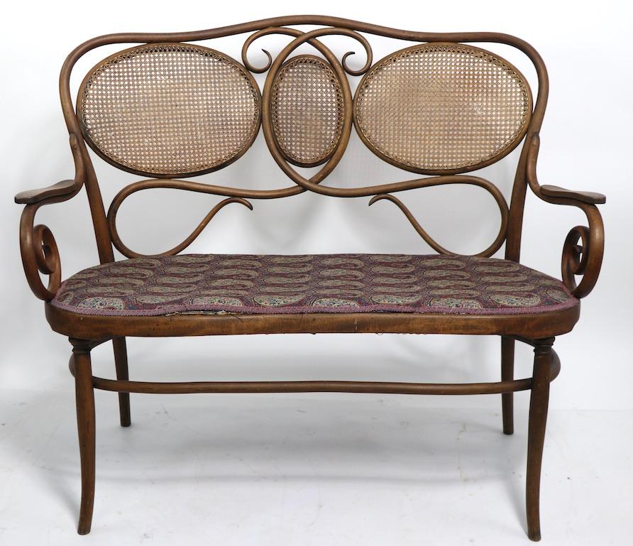 Attractive bentwood bench from the Vienna Secessionist Movement by J J Kohn. This example is selling in good condition, but shows signs of wear and use. Specifically, the seat is currently in later, not original, upholstered fabric, original seat