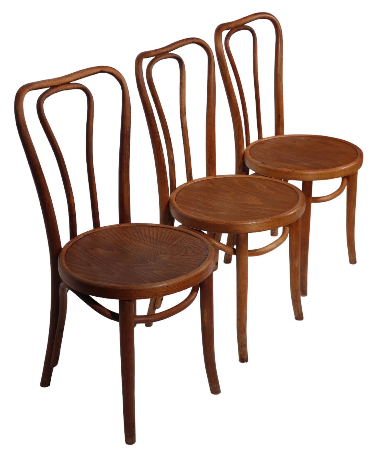Classic cafe, bistro, dining  chair (s), attributed to Thonet. Constructed of steam bent beech wood, with original pressed wood seats. Executed in the Vienna Secessionist style, circa 1920/1950, made in Poland.  We have three of these available,
