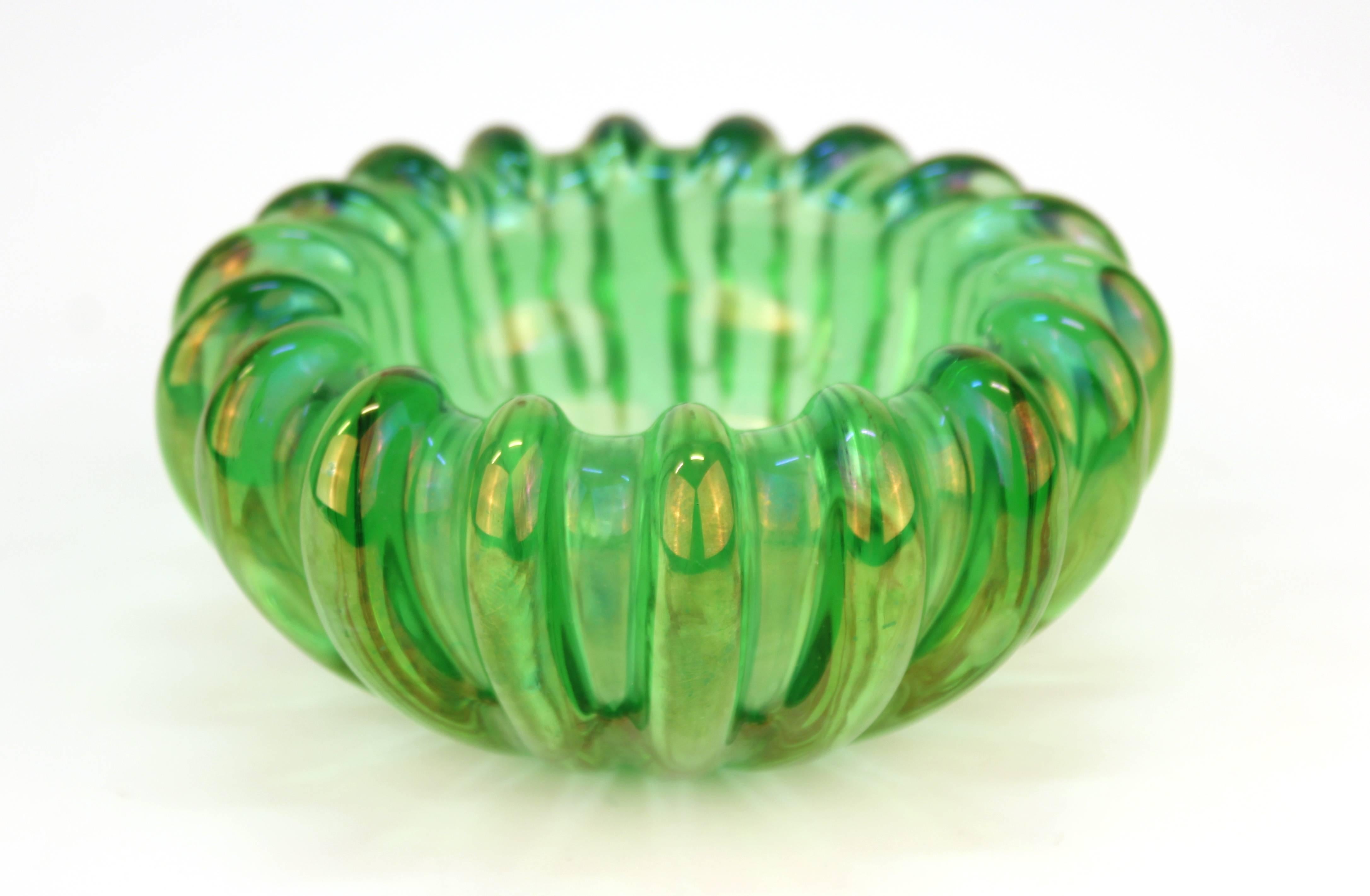 Vienna secessionist bowl in opalescent green glass, with thick heavily ribbed sides, the interior with several trapped bubbles. Small crescent nick to the underside and minor scratches, but overall in good vintage condition.