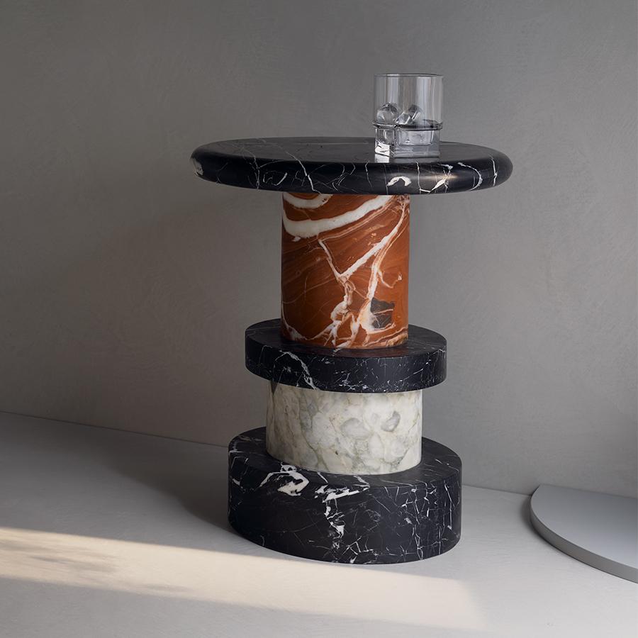 With a nod to the postmodern structures of Ettore Sottsass and a character all its own, the Vienna side table draws on the natural beauty of marble to blend monochromes with a little fire.

Made from solid, honed pieces of Rosso, Nero and Fiore