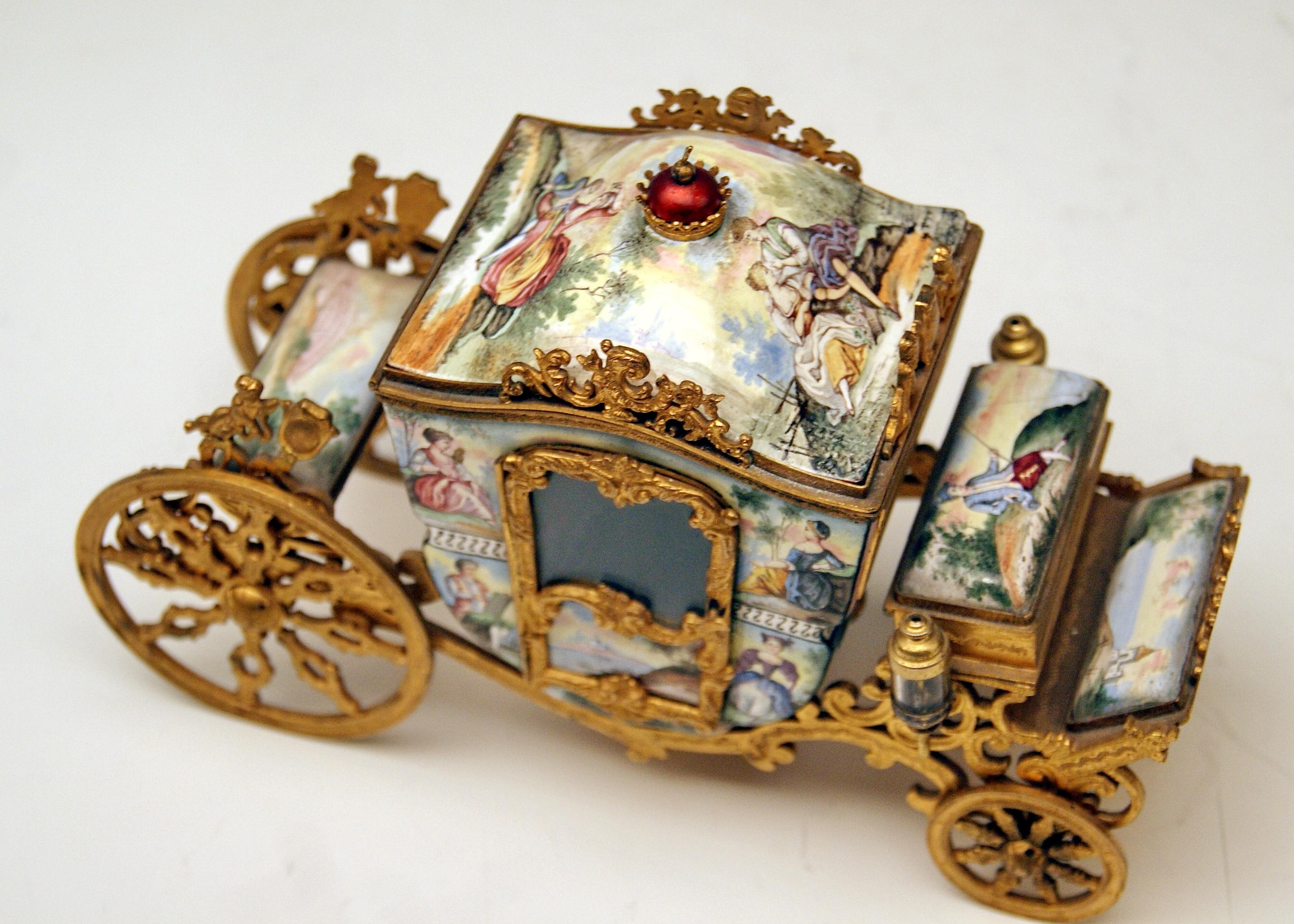 Vintage Viennese enamel item decorated with paintings and gilt bronze mountings:
Carriage on wheels with glassed doors

Specifications:
1. The surface of carriage is stunningly painted with enamel, showing couples situated in romantic