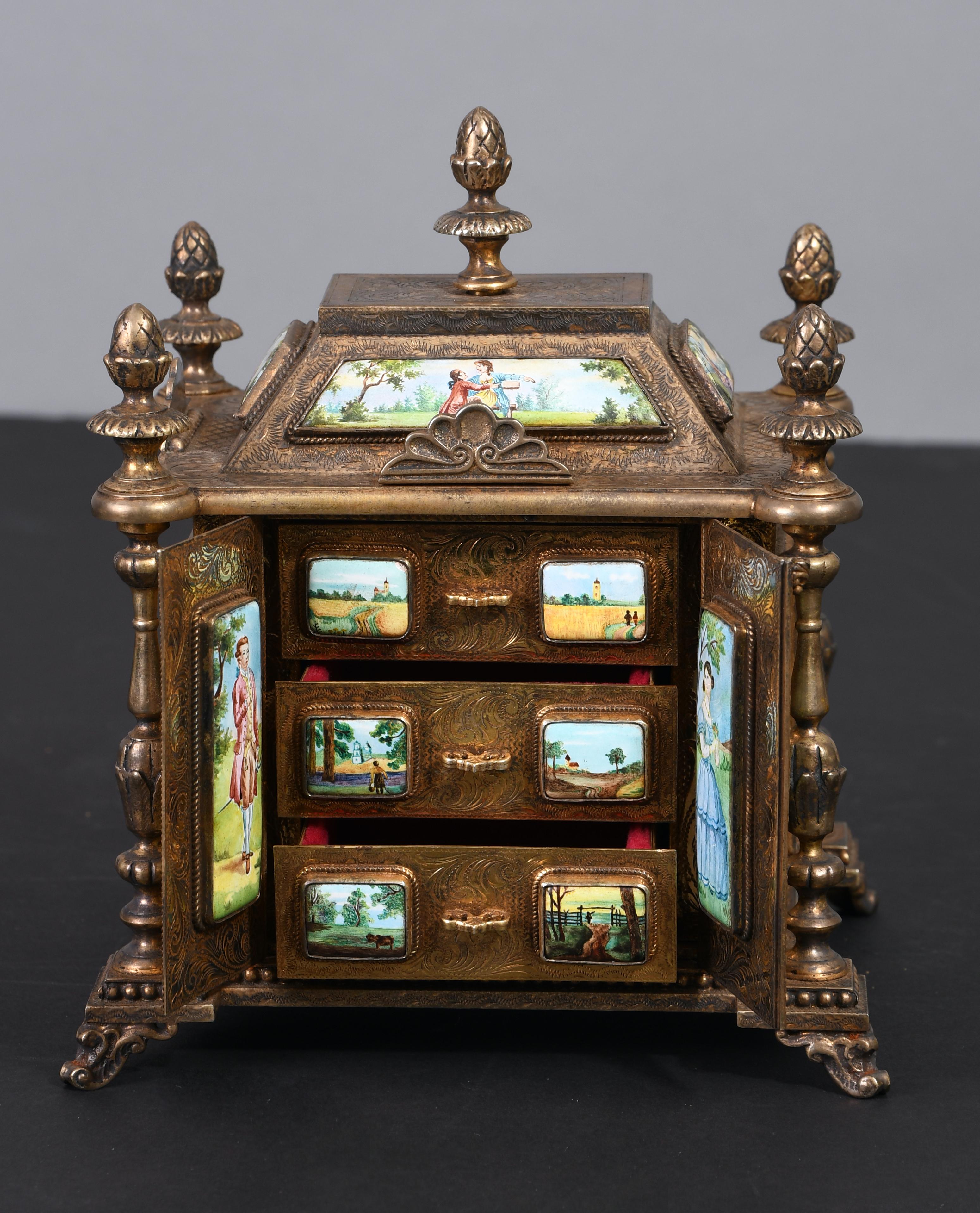 This jewelry box is built similar to a Roman/Greek Pantheon with 17 Silver bordered hand painted enamel panels. The panels are embellished with romantic pastoral couple scenes and portraits of ladies and gentlemen. The walls of the architectural