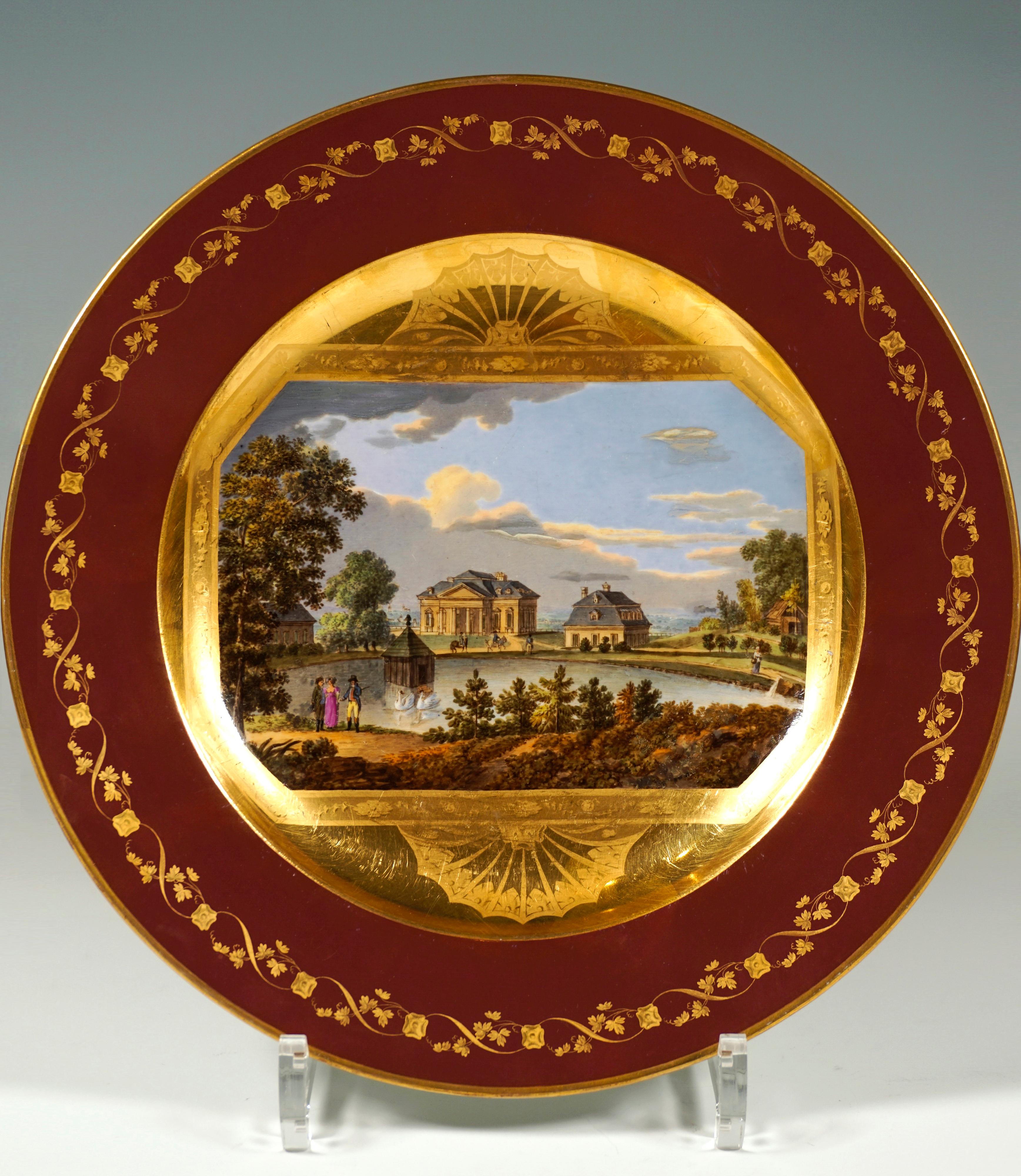 Porcelain plate decorated with fine veduta painting: In the mirror an octagonal picture panel in front of a golden background with a border of 
leafy vines painted in matt gold and fan medallions above and below the picture, depicting the castle of