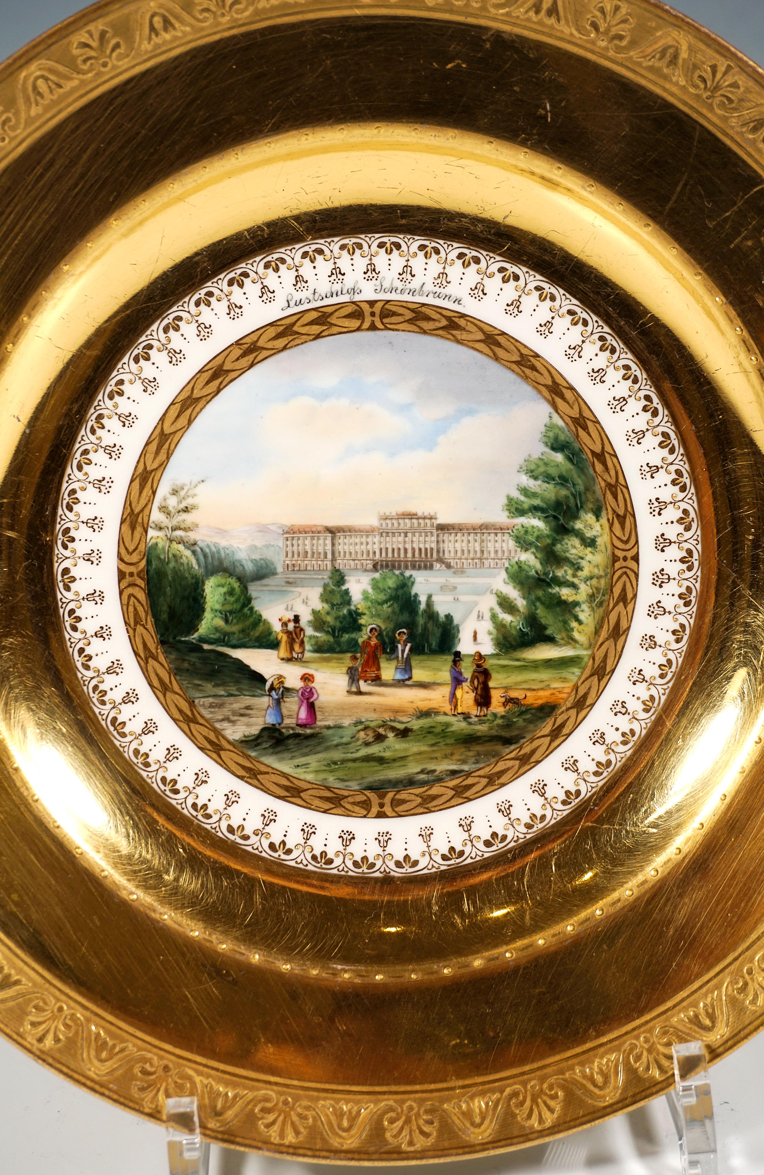 Porcelain picture plate with a finely painted polychrome veduta: In the centre, a view of the Viennese summer palace of Schönbrunn with its gardens, as seen from the hill opposite, with figures, framed by a border in matt and bright gold, delicately