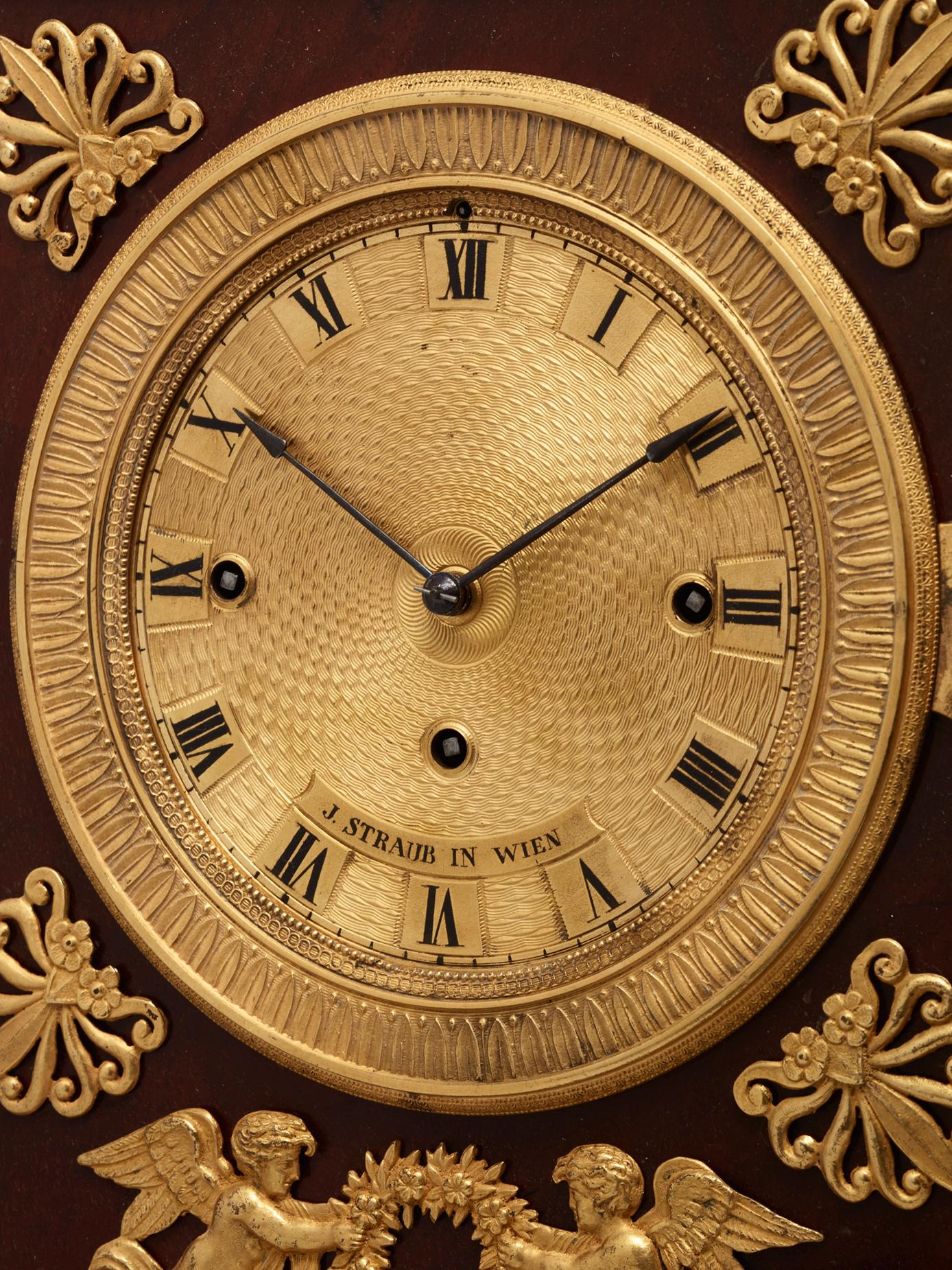 Une très charmante horloge de cheminée viennoise joliment décorée, signée J Straub à Wien.

Les bronzes guildés, ravissants et détaillés, sont d'une très grande qualité. Sous le beau cadran guilloché signé, deux charmants anges portant une couronne.