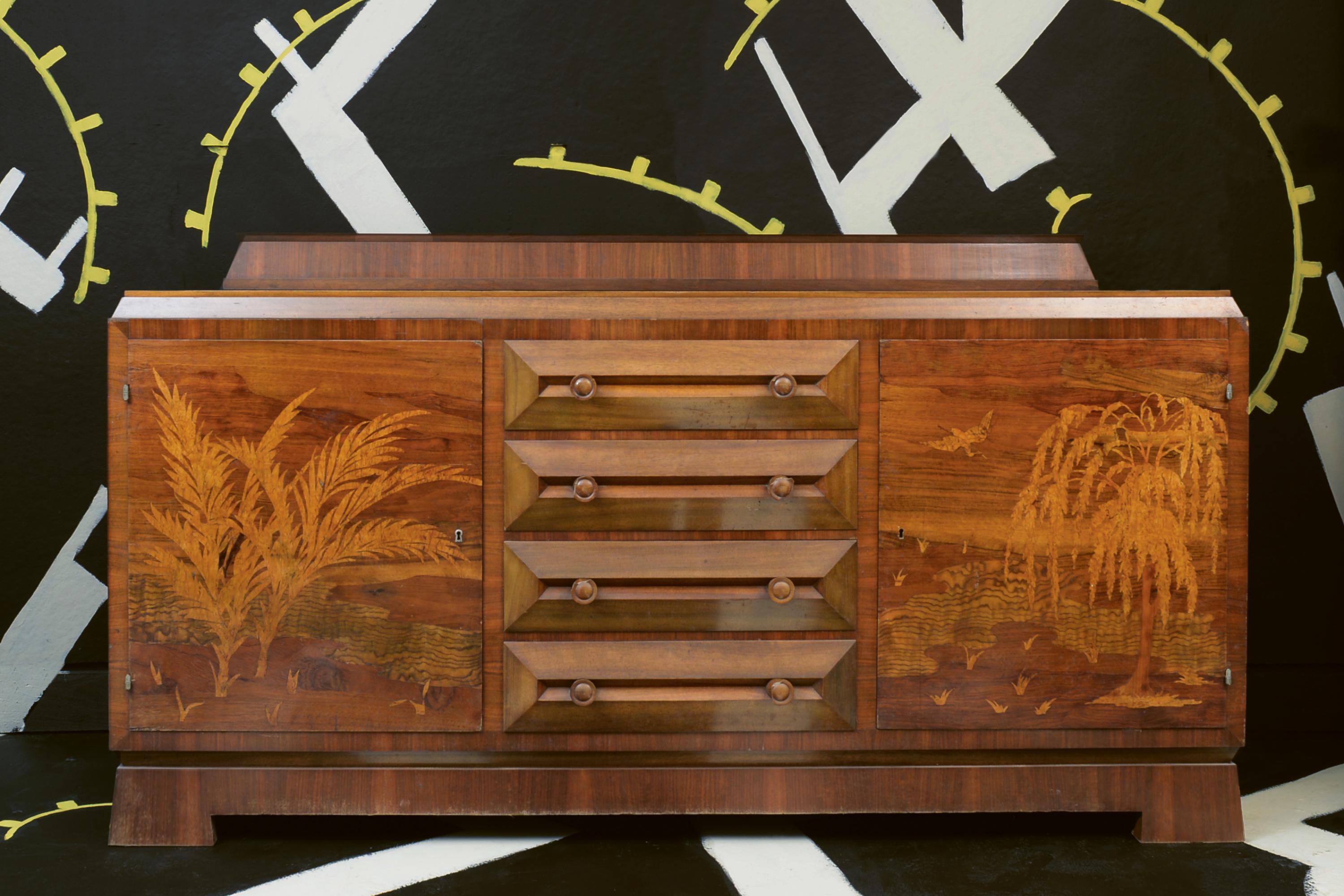 Viennese Neues Wohnen Sideboard with Marquetry Landscape, c. 1926

This rare walnut-veneered sideboard, attributed to Rudolf Lorenz’s firm Kunst und Wohnung, is an evocative example of Viennese applied arts during the interwar period. Created around