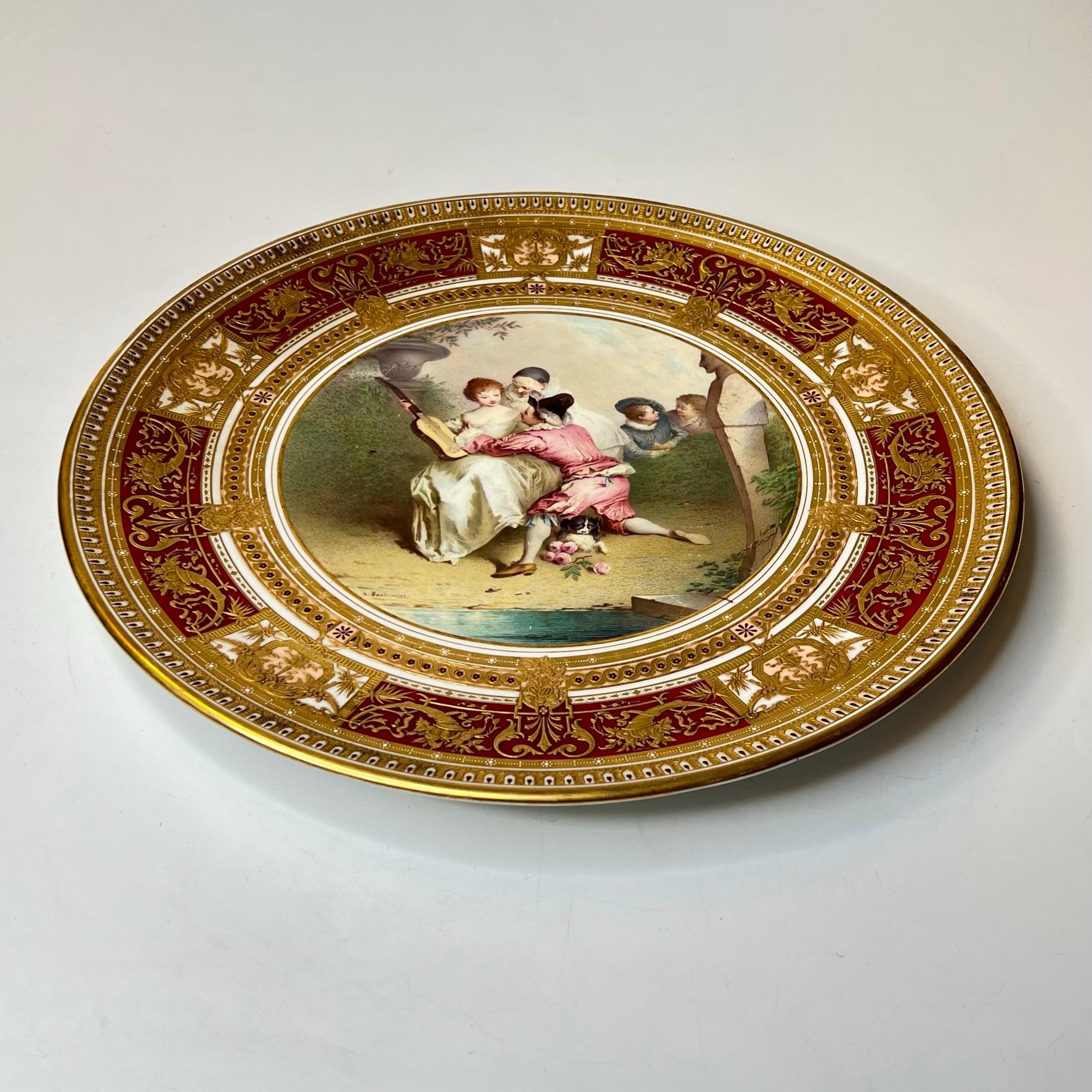 Antique Royal Vienna porcelain plate painted by Antonin Boullemier (1840-1900), depicting courting lovers and with extensive neoclassical mofits and gilt decorations.  Excellent condition, with scattered light scratches and light rubbing wear.