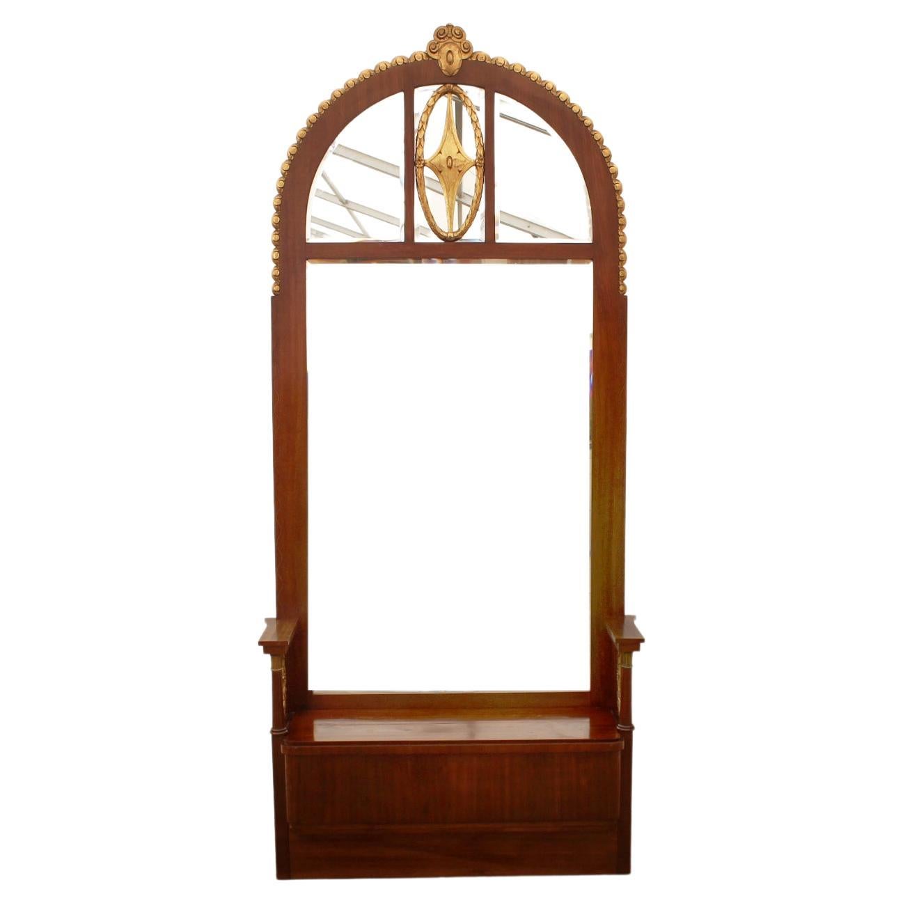 A large mirror with storage space from the Viennese Art Nouveau period. The mirror features elements and shapes including gilded decorative motifs typical of the Art Nouveau period. It was manufactured in Austria-Hungary at the beginning of the 20th