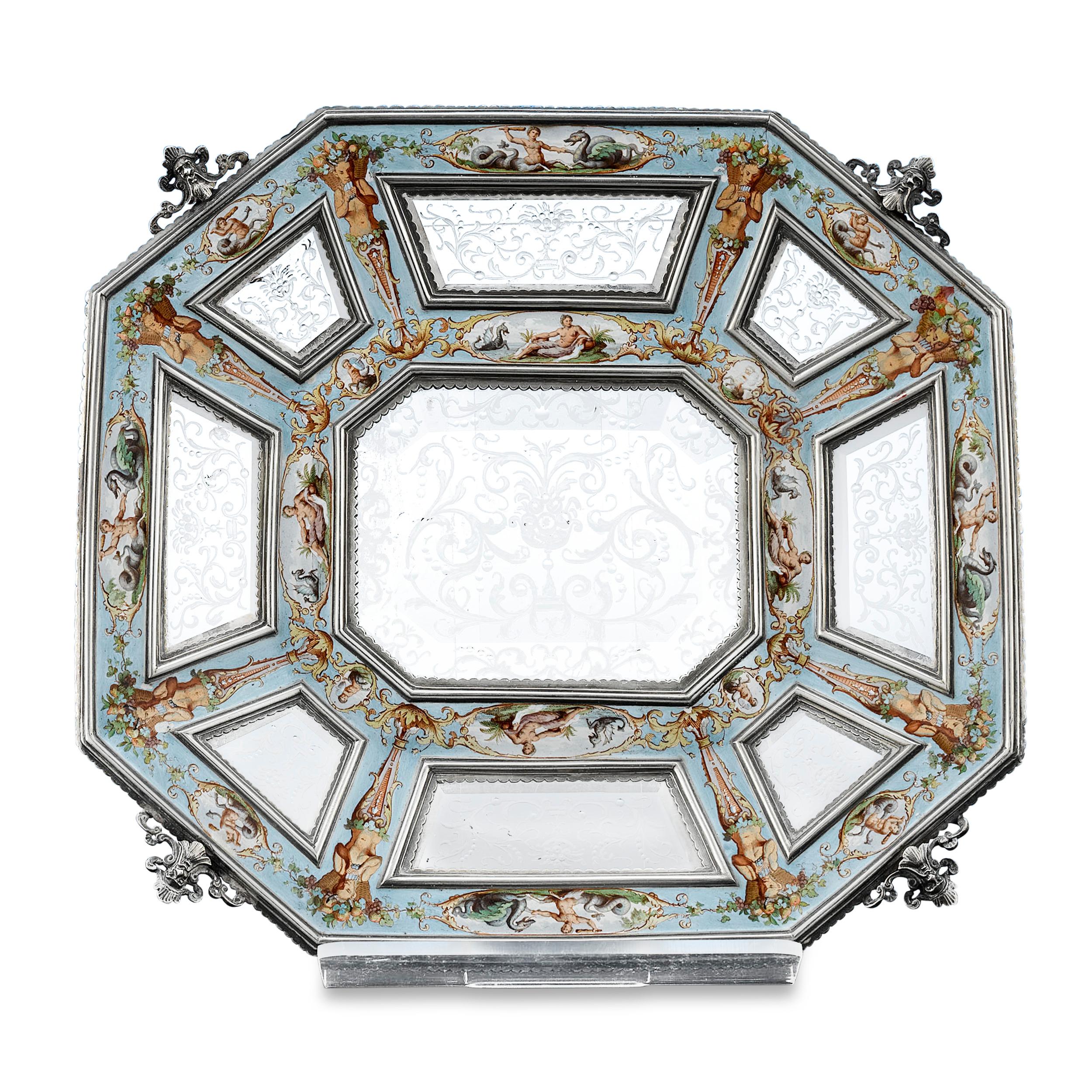 This magnificent Viennese salver, intricately carved from solid rock crystal, combines the mastery of the Viennese enameling tradition with the radiance of rock crystal. Mounted in a silver frame, plaques of intricately etched natural quartz are