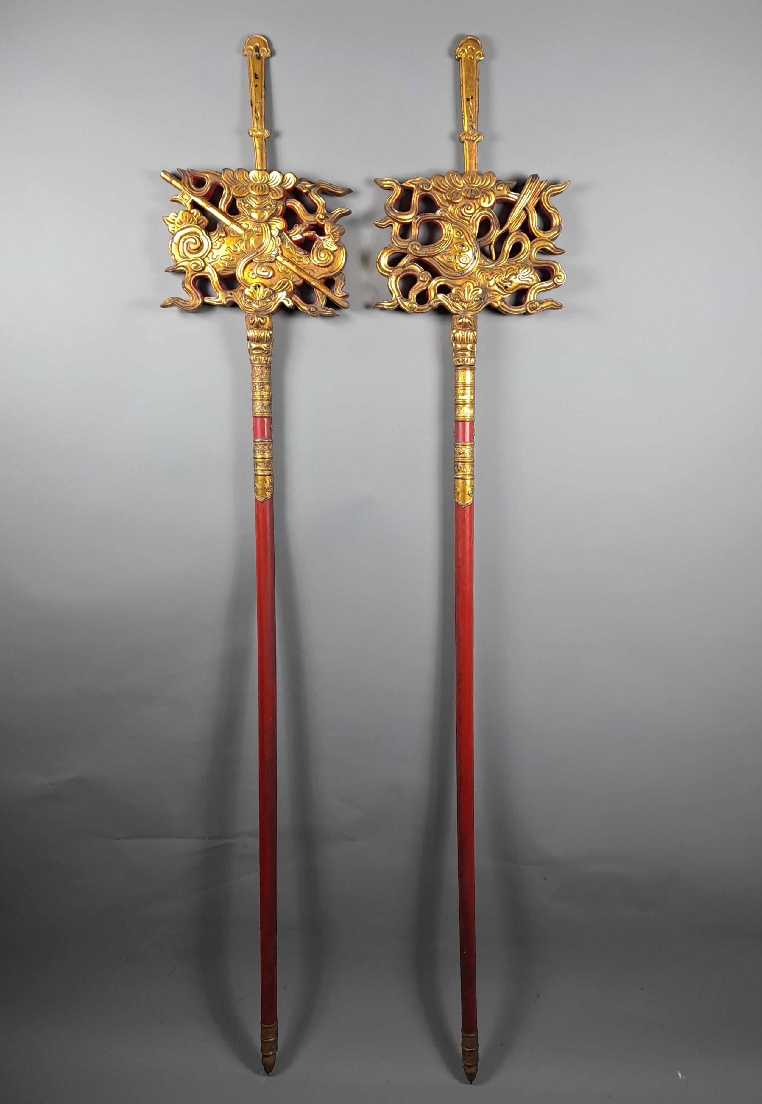 Pair of large, richly carved, gilded and red lacquered wooden standards.  
 A religious and decorative object in Vietnamese temples and pagodas.  
Different decor each side.  
Brought back from Indochina in the early 20th century.   
19th century