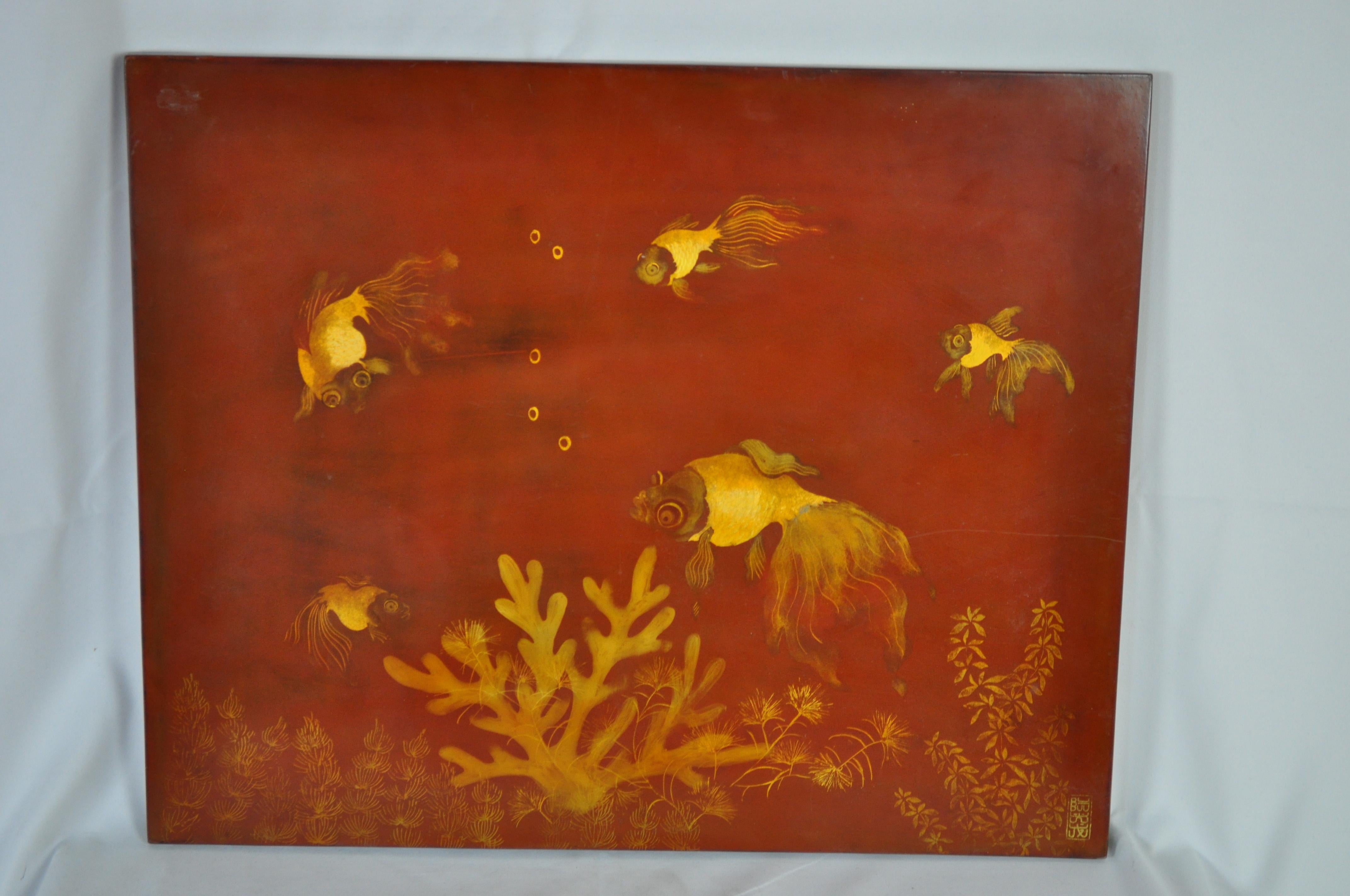 Vietnamese lacquer painting signed by N'Guyen Quang Long, 1940. Red background with gold lacquer fishes and corals.