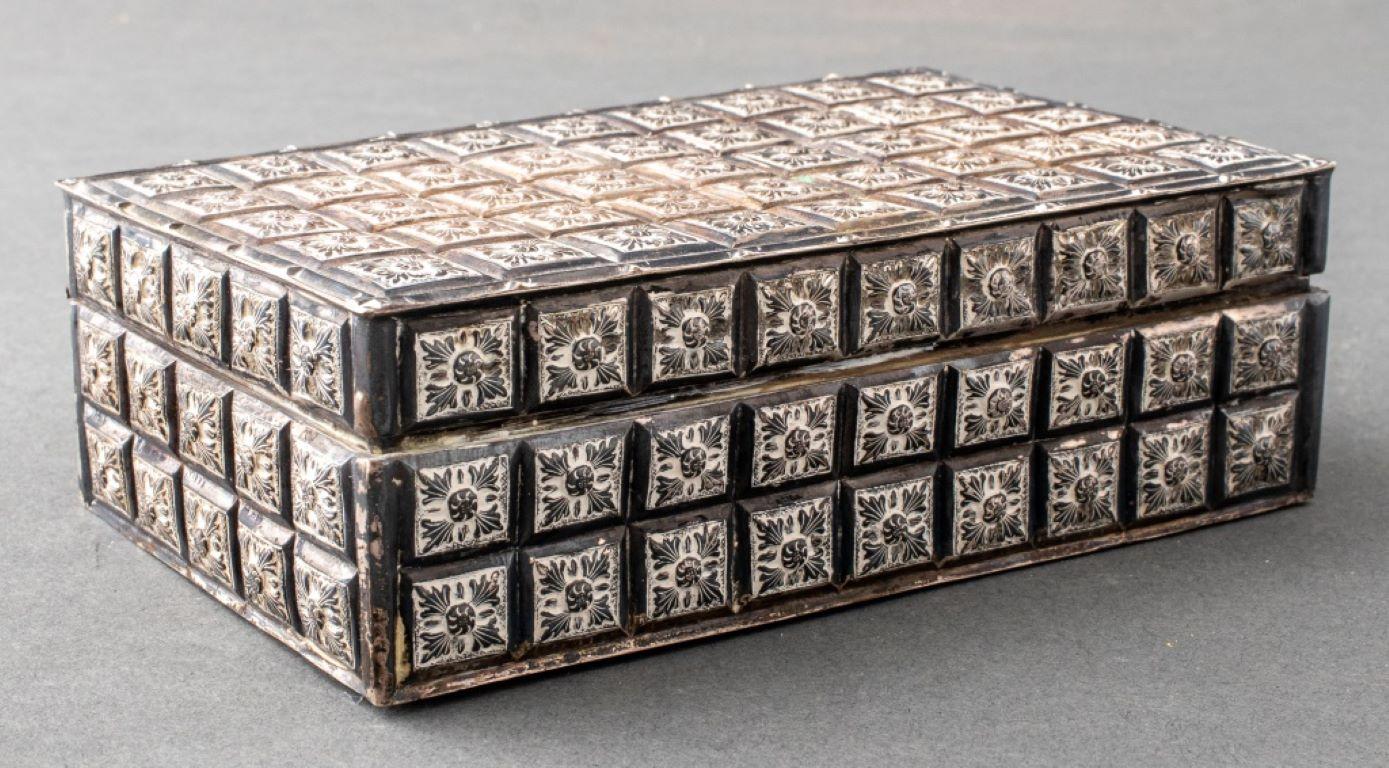 Vietnamese hinged covered silvered metal table box decorated with repousse foliate vignettes in a grid pattern, marked 