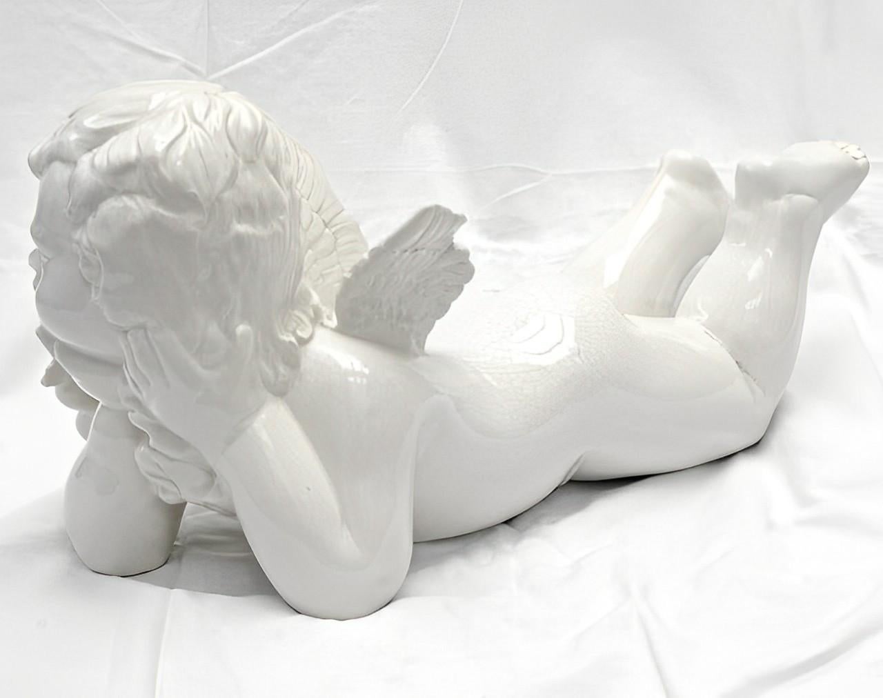 Lovely Vietri large white crackle glazed ceramic cherub figurine. Made in Italy. Measuring length 53cm / 20.86 inches by maximum width 22cm / 8.66 inches, and height 24cm / 9.44 inches. There is a bit of damage to his face, but this is a vintage
