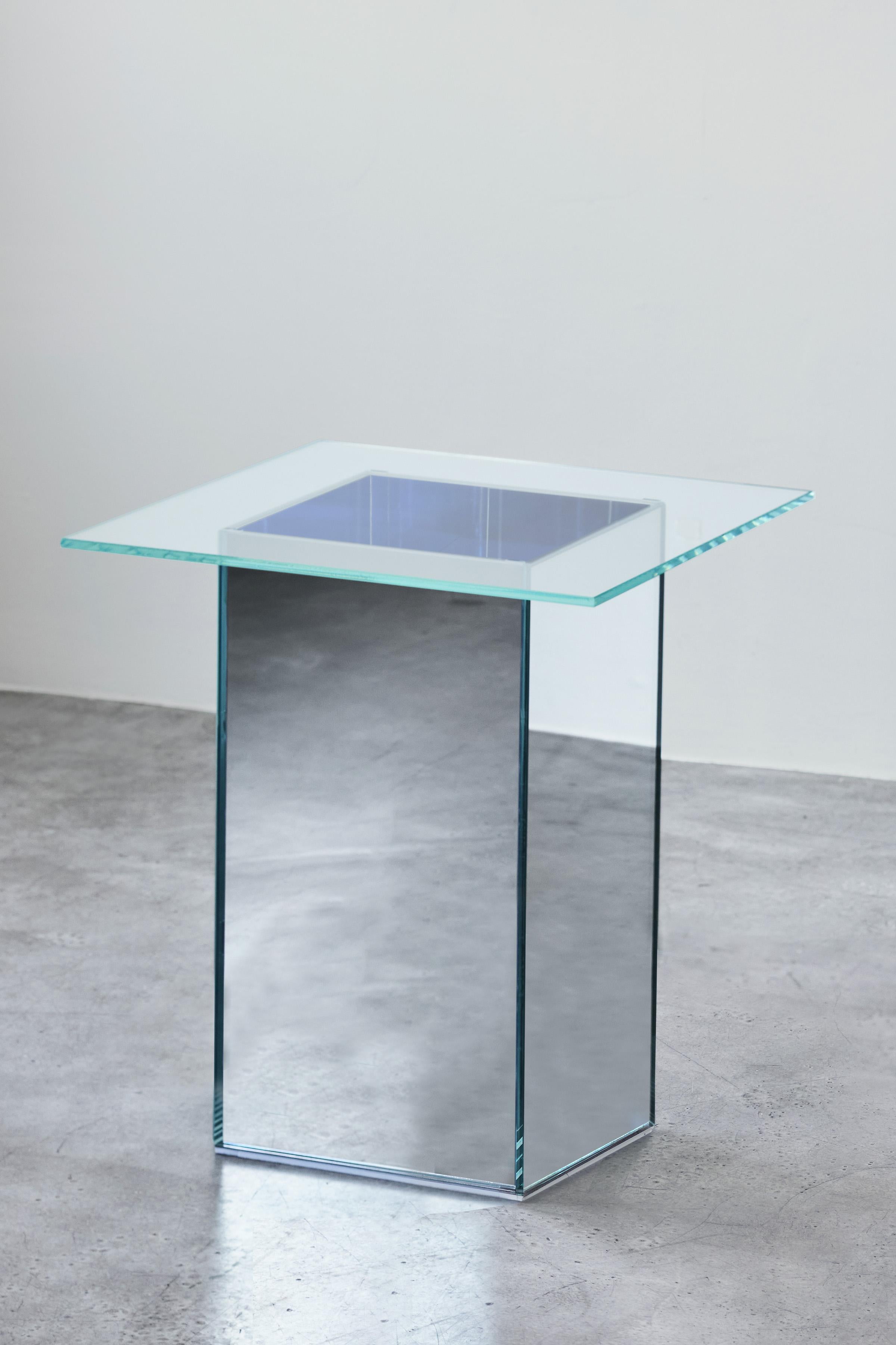 VIEW Tea Table is part of a five-piece collection of sculptural glass and mirror furniture seeking to bring interactive views into objects and furniture. VIEW Tea Table is made from ultra-clear low-iron glass and mirrored glass base. While furniture
