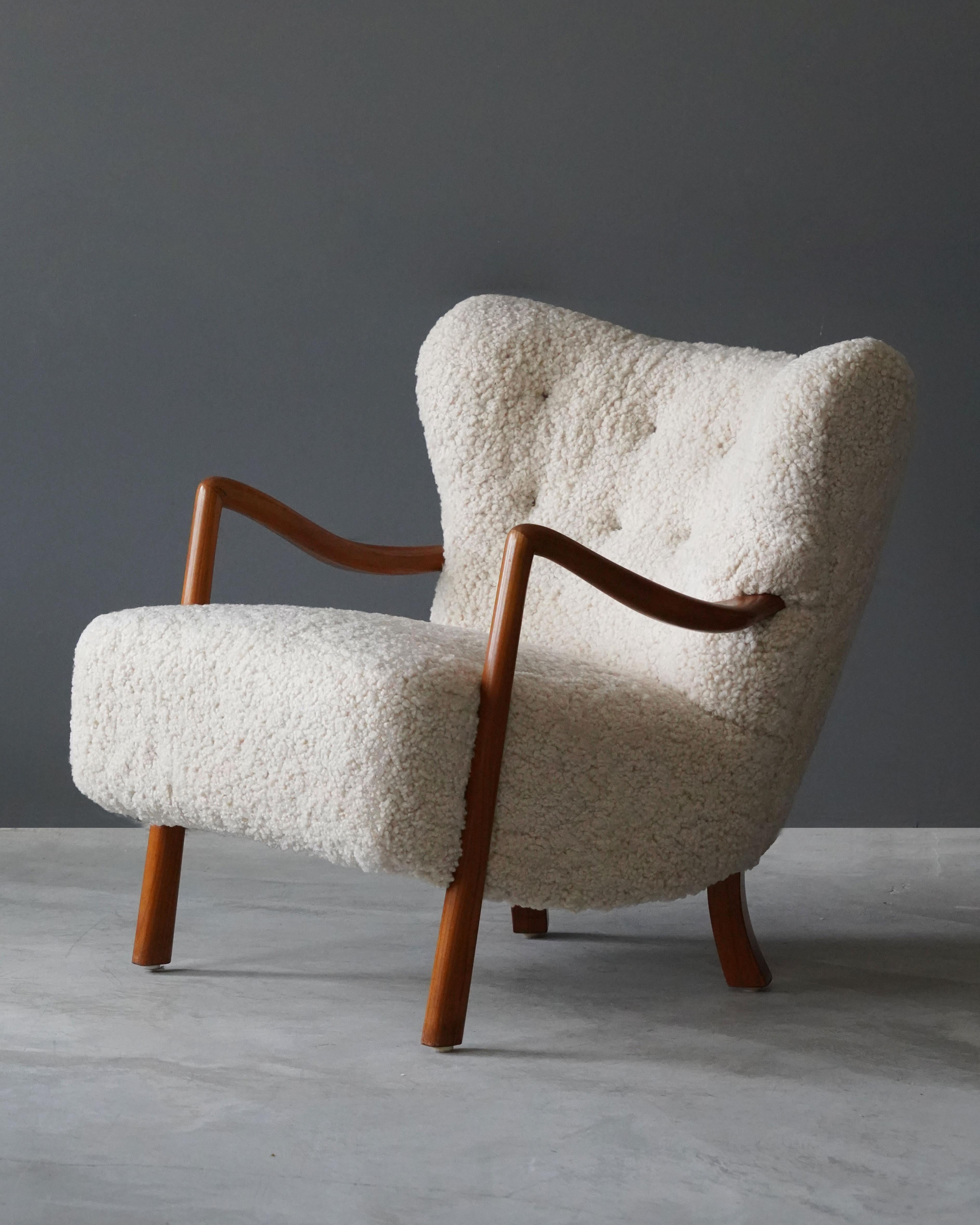 An organic lounge chair attributed to Viggo Boesen. The overstuffed form is contrasted by stained beech arms and legs. 

Other designers working in the organic style include: Peder Moos, Flemming Lassen, Jean Royère, Gio Ponti and Philip Arctander.