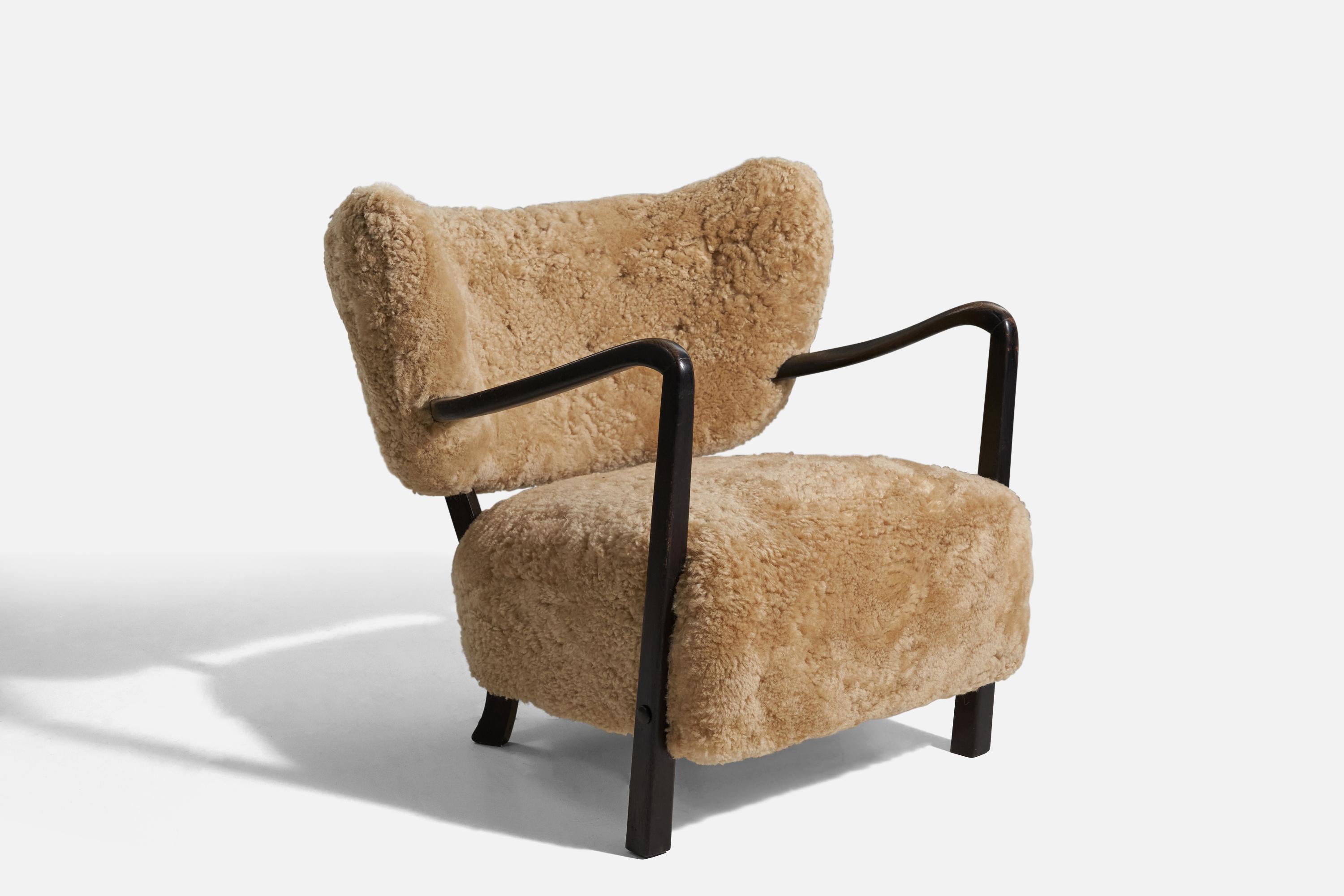 A wood and shearling lounge chair design attributed to Viggo Boesen. Likely produced by Hos Wulff c. 1940s, Denmark.


  

