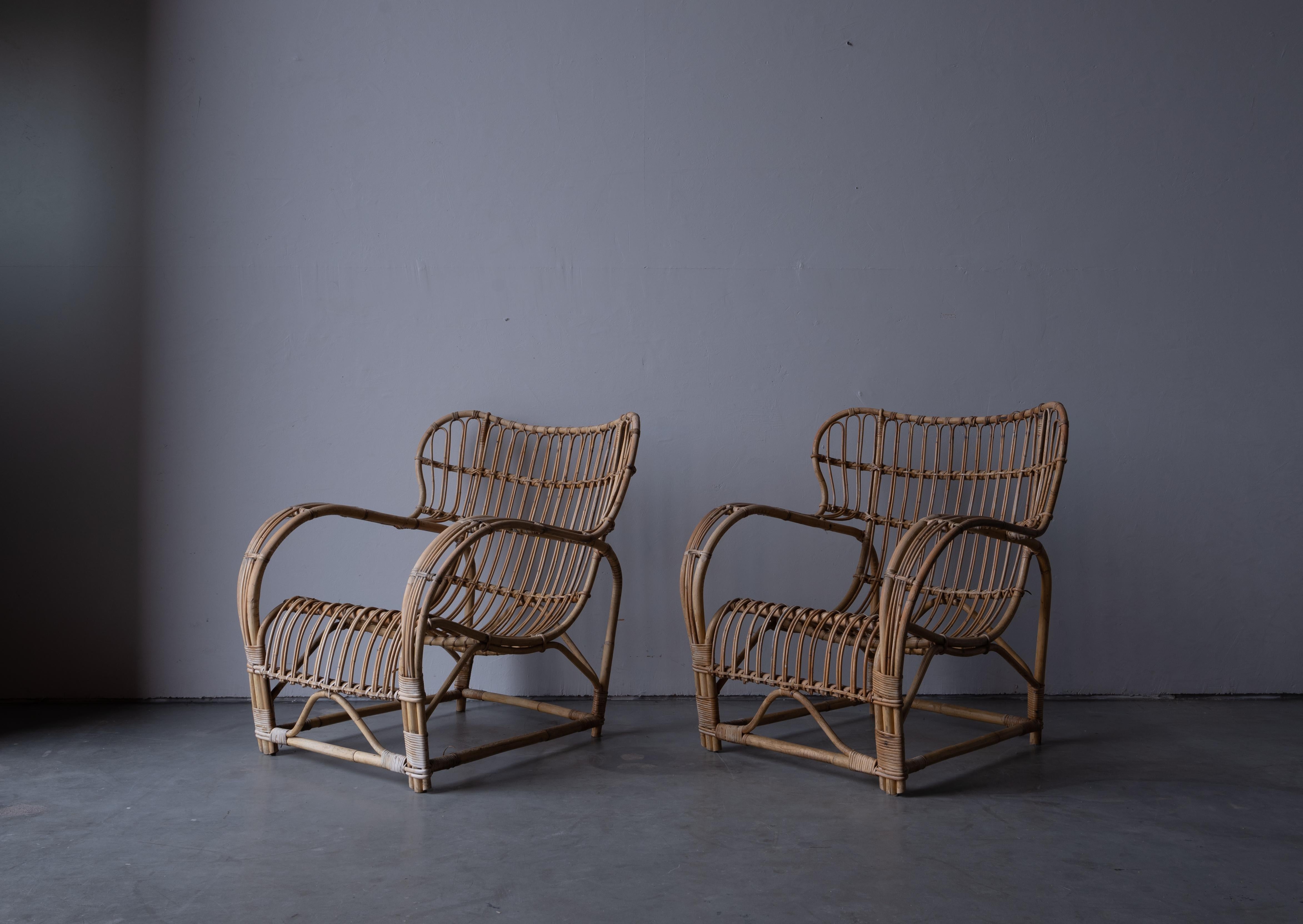 A pair of lounge chairs. Design attributed to Viggo Boesen. Presumably produced by E. V. A. Nissen & Co., Denmark. c. 1940s-1950s.

In moulded bamboo with rattan / cane details.

Other designers of the period include Gio Ponti, Jean Royère,