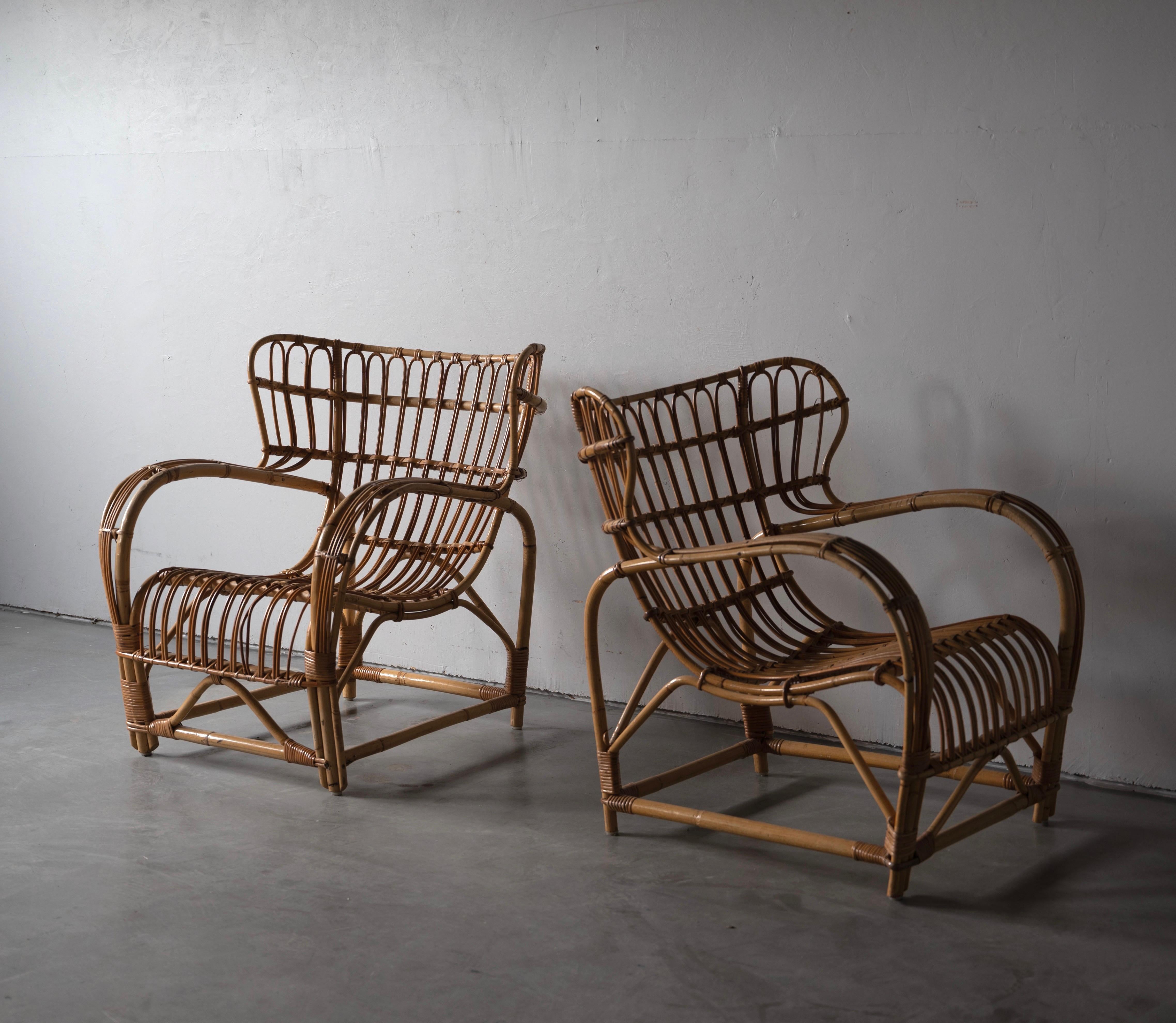 A pair of lounge chairs. Design attributed to Viggo Boesen. Presumably produced by E. V. A. Nissen & Co., Denmark. c. 1940s-1950s.

In moulded bamboo with rattan / cane details.

Seat height measured from highest point of seat.

Other
