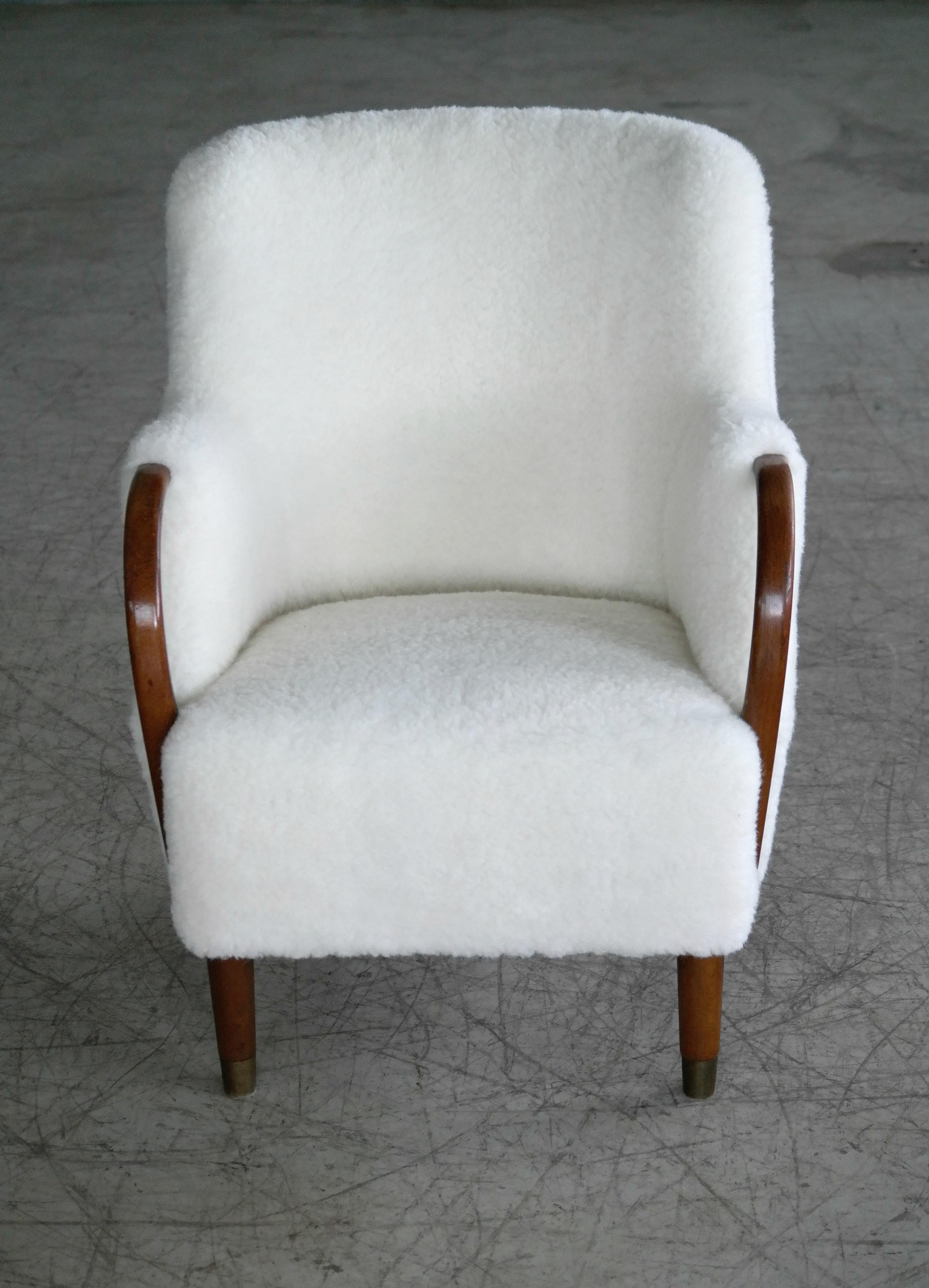 Unique and just superb lounge chair with open armrests designed and made as a match the model 96 settee by N.A. Jørgensens Møbelfabrik around 1955. N.A. Jørgensen is better known under the name Bramin Mobler a name they adopted in the 1960s. N.A.
