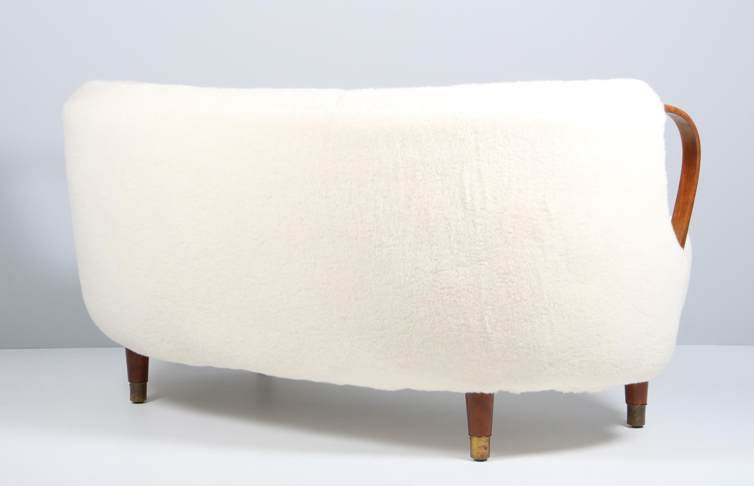 Unique and just superb curved or banana shaped loveseat or settee with open armrests designed and made as Model 96 by N.A. Jørgensens Møbelfabrik in 1954/55. N.A. Jørgensen is better known under the name Bramin Mobler a name they adopted in the