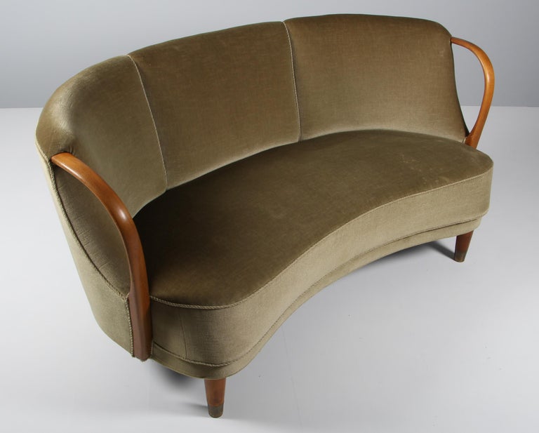 Unique and just superb curved or banana shaped loveseat or settee with open armrests designed and made as Model 96 by N.A. Jørgensens Møbelfabrik in 1954/55. N.A. Jørgensen is better known under the name Bramin Mobler a name they adopted in the