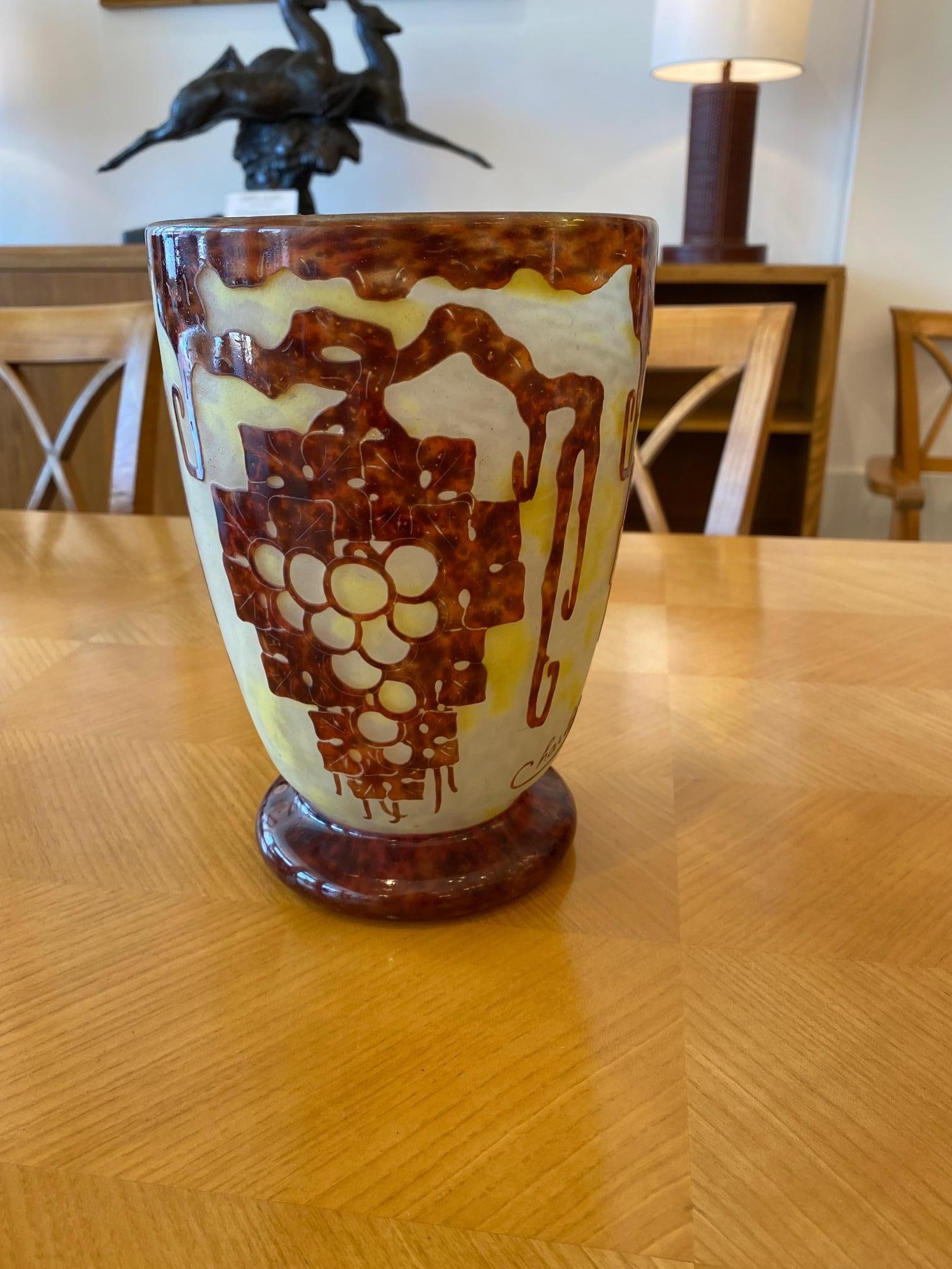 A French glass vase in Mottled Opaline Yellow and Yellow glass overlaid with a bunch of grapes in Violet.  The pattern is acid-etched.  The design of this vase is by Le Verre Français - Charder and it is from the Vigne serie.
Signature :  Le Verre