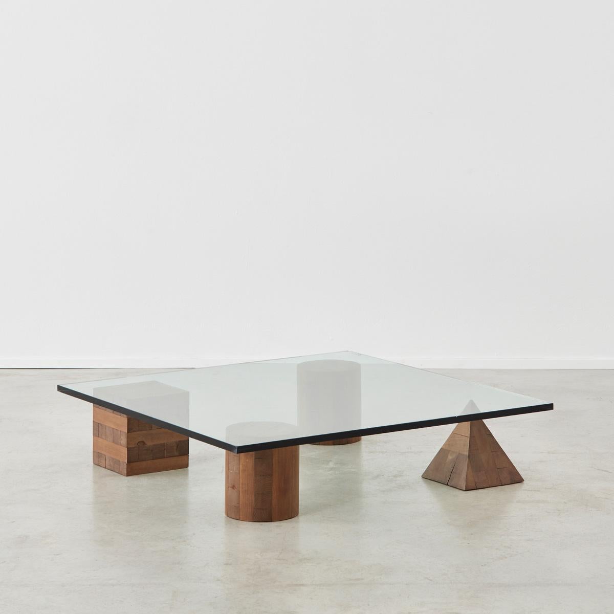 A stunning and sculptural Metafora coffee table designed by Lella and Massimo Vignelli. Inspired by the four forms of Euclidean geometry, the cube, the pyramid, and two cylinder, the four elements can be positioned freely for a unique