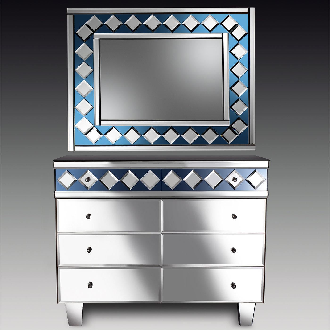 A contemporary dresser featuring silver mirror drawers with blue geometric embellishments. This piece is entirely handmade my master Murano artisans.