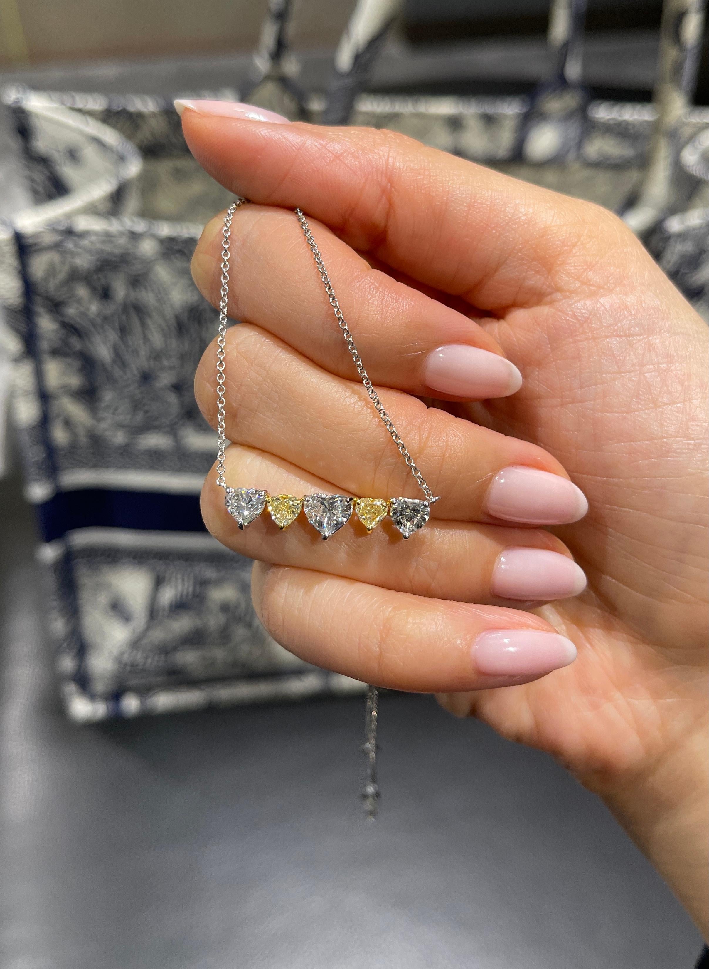 Vihari Jewel's five stone pendant necklace features 5 diamonds: 3 heart shape white diamonds (F color, VS+ clarity) and 2 heart shape Fancy Yellow diamonds (VS+ clarity).  The pendant and chain are 18K White and Yellow Gold and the clasp closure