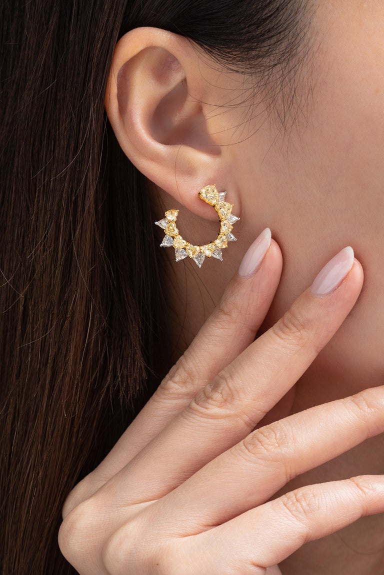 These Vihari Jewels heart shape Yellow and White Diamond half loop earrings will bring warmth to your wardrobe, leaving your ears sunkissed. The earrings feature 18 Fancy Yellow heart shaped diamonds, totaling 5.67 carats (VS+ clarity) and 16 white