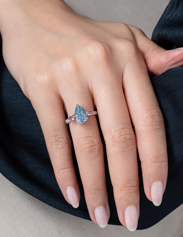 This elegant and refined collector's piece from Vihari Jewels features a 3.17 carat Fancy Intense Blue pear shape diamond (GIA Certificate #5171223455) surrounded by a 0.23 carat Fancy Vivid Pink Diamond (GIA Certificate #6203773996) and a 0.20