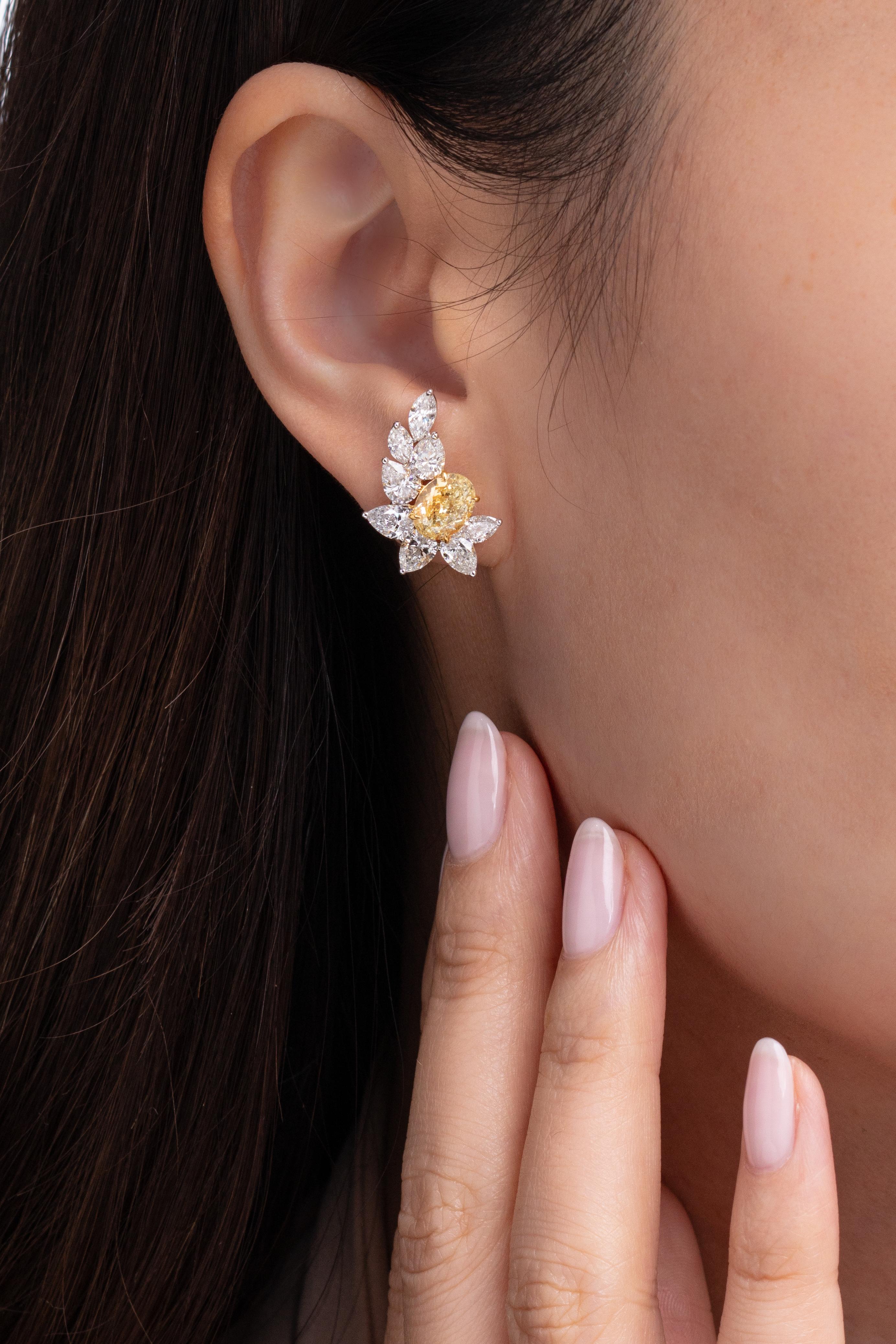 A matching pair of Fancy Yellow oval shaped diamonds earrings from Vihari Jewels, featuring an identical carat weight of 1.51 carats each (GIA Certificate #5191009259 and GIA Certificate #519830016). Both Fancy Yellow diamonds are VS+ in clarity.