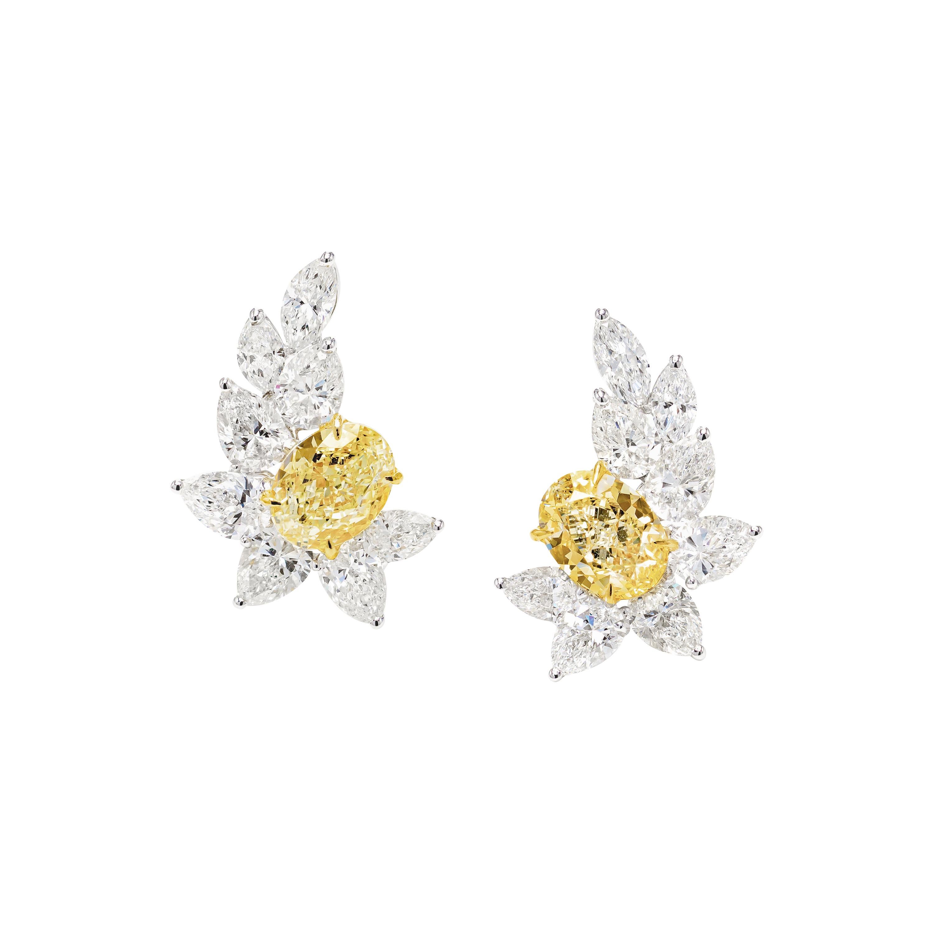 GIA Certified 7.09 Carat Fancy Yellow Oval Diamond Earrings in 18K Gold For Sale