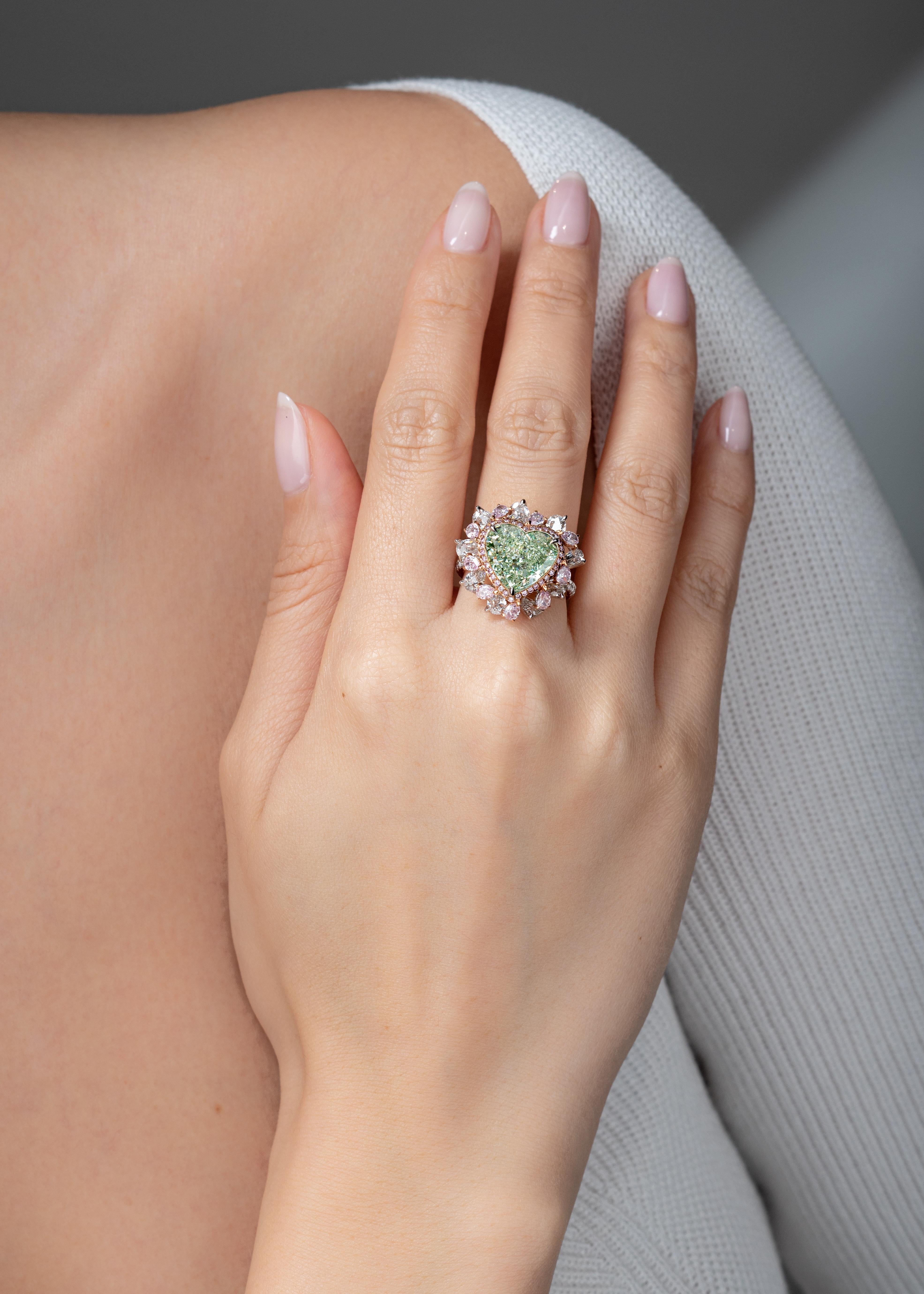 A 5.29 carat Fancy Yellow Green heart shape diamond with VS2 clarity (GIA Certificate #5171179493) is the feature stone of this Vihari Jewels ring. Green diamonds are symbolic of nature and harmony - attributes that Vihari wanted to highlight in her