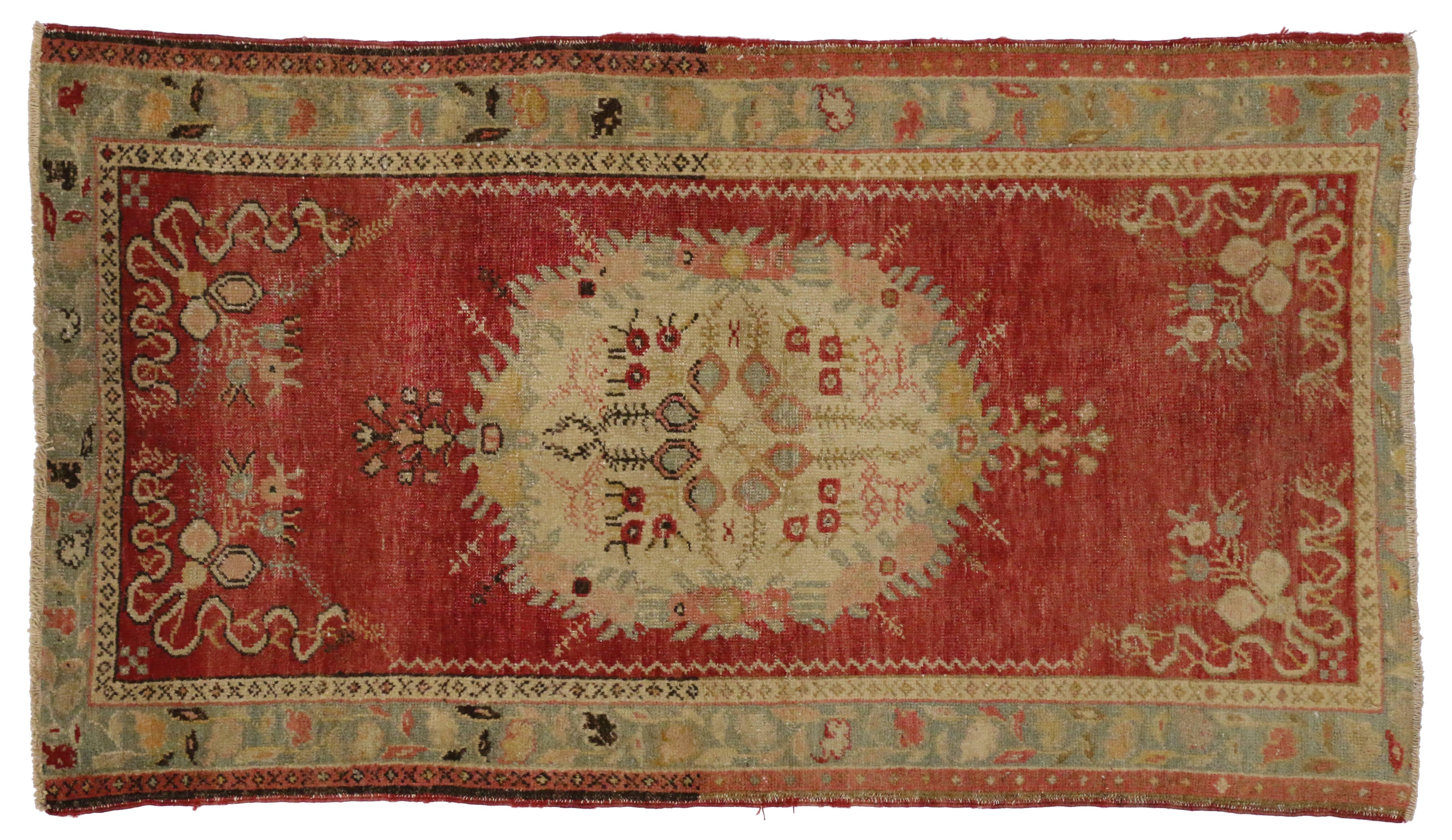 51400 a vintage Oushak accent rug. This charming vintage Turkish Oushak rug features a central stylized medallion of light eggshell with a geometric flower in faded azure bordered with crimson flowers in a reflective scheme and flanked by two lush