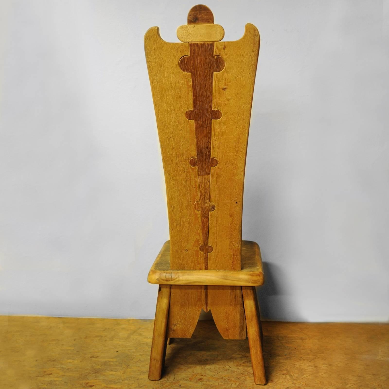 This stunning chair is part of the Throne collection, featuring 20 different designs, all inspired by the tall backrests of thrones. Crafted using reclaimed fir, Swiss pine, pine, and larch coming from the floors of 16th century houses, this chair