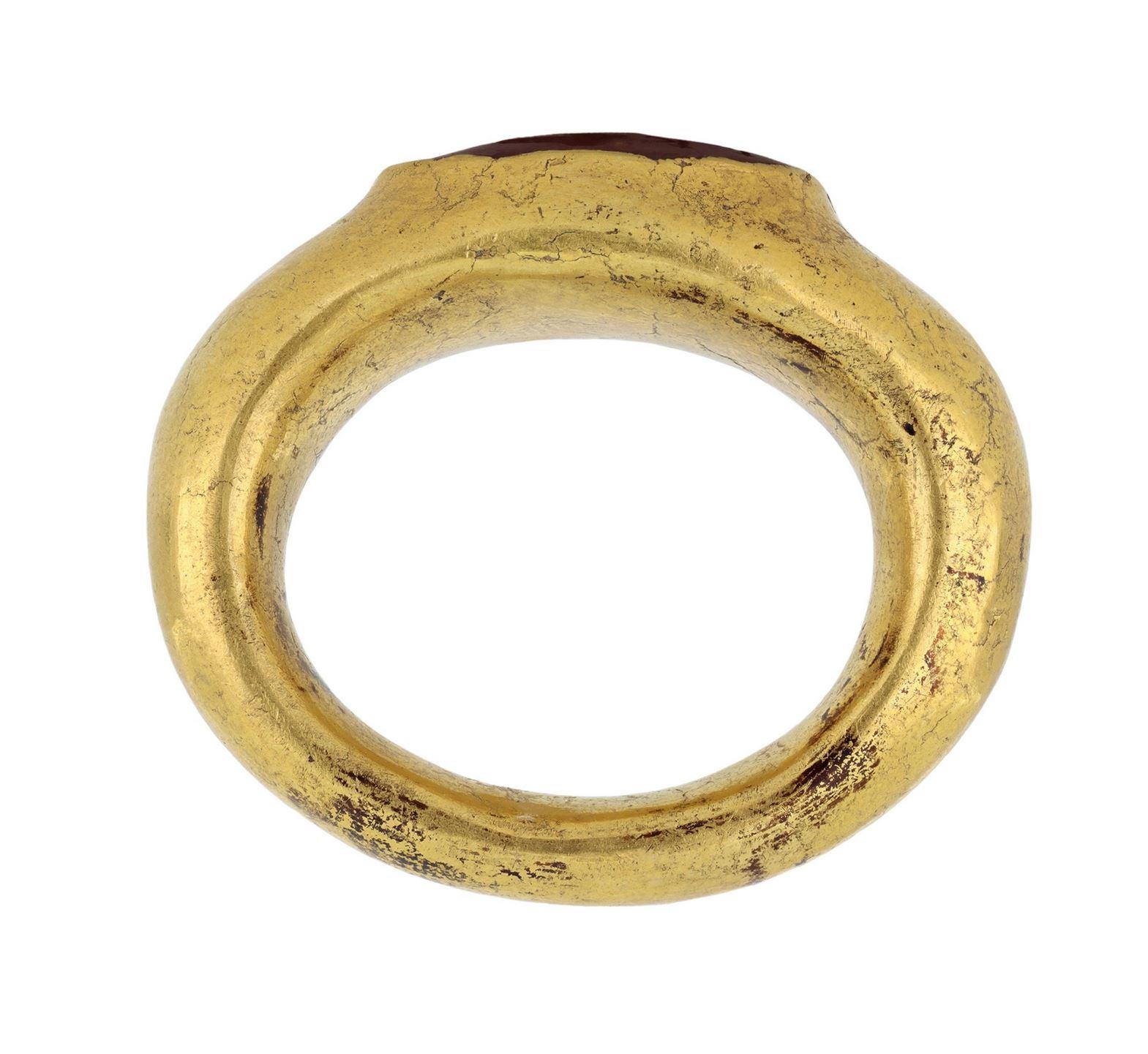 Viking yellow gold stamped ring. A smoothly conforming yellow gold ring with a continuous geometric pattern created by adjacent triangular stamps and border by raised champfered edges, approximately 7mm in width. Tested yellow gold, approximately