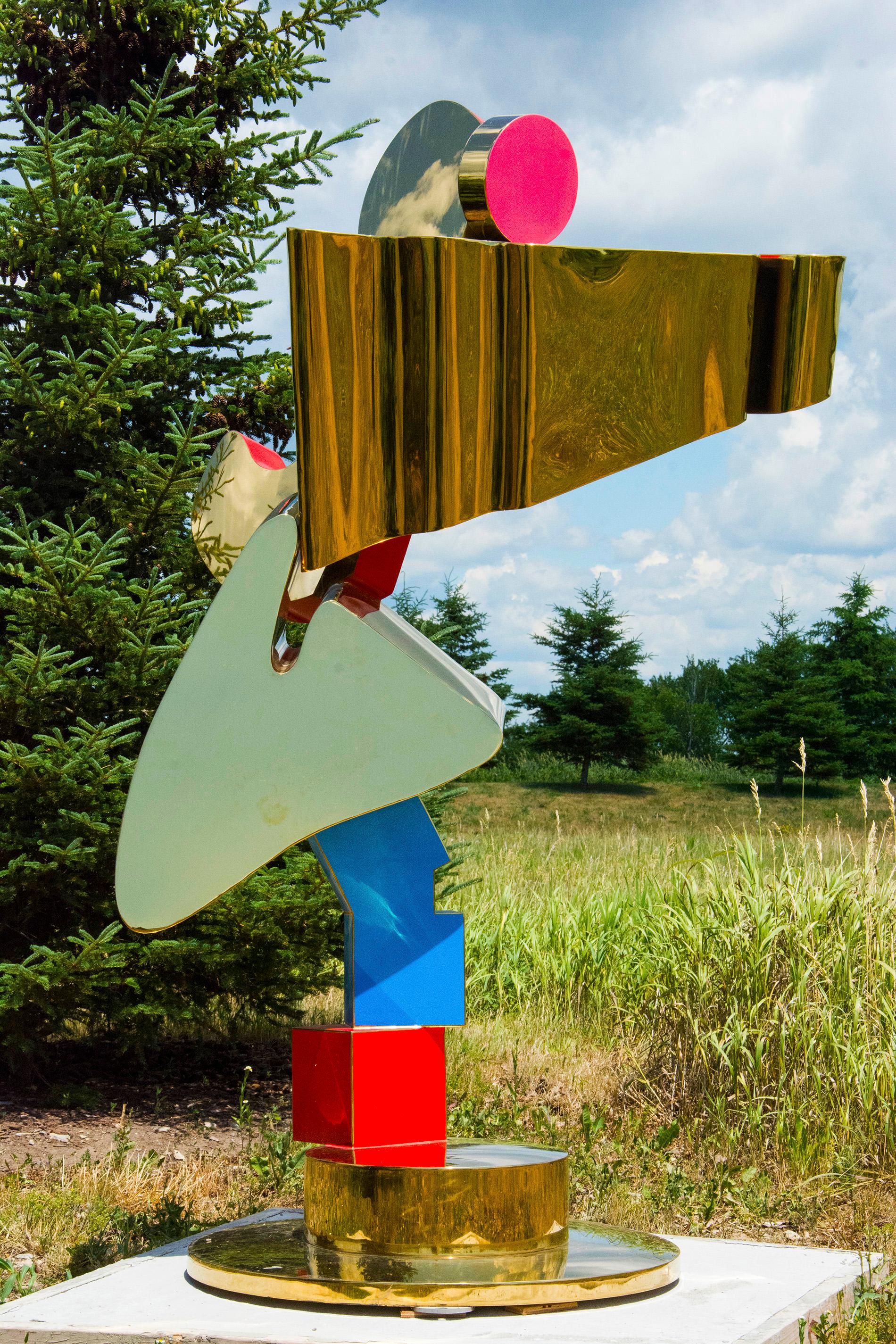 A column of colorful and precariously stacked shapes glitters in the sun. This playful outdoor sculpture by Viktor Mitic may also be installed indoors.

Serbian-born Viktor Mitic earned a BFA from the University of Toronto in 1995 with studies in