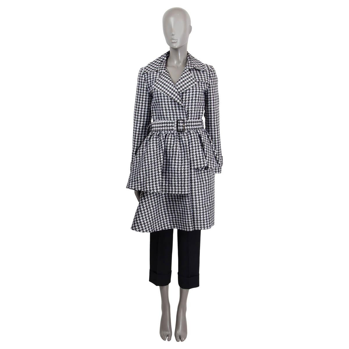 100% authentic Viktor & Rolf houndstooth asymmetrical trench coat in black and silver polyester (84%) and silk (16%). Features a detachable belt, epaulettes on the cuffs and two side slit pockets. Opens with push buttons on the front. Lined in black