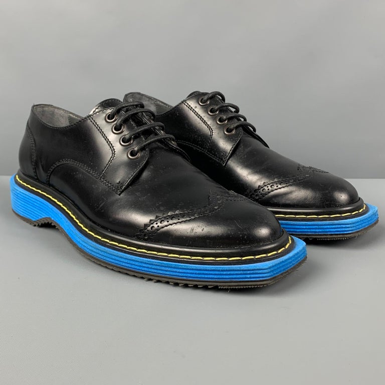 VIKTOR & ROLF shoes comes in a black perforated leather featuring a wingtip style, blue trim, chunky sole, and a lace up closure. Made in Italy. 

Good Pre-Owned Condition. Minor wear.
Marked: 43

Outsole: 12.75 in. x 5 in. 