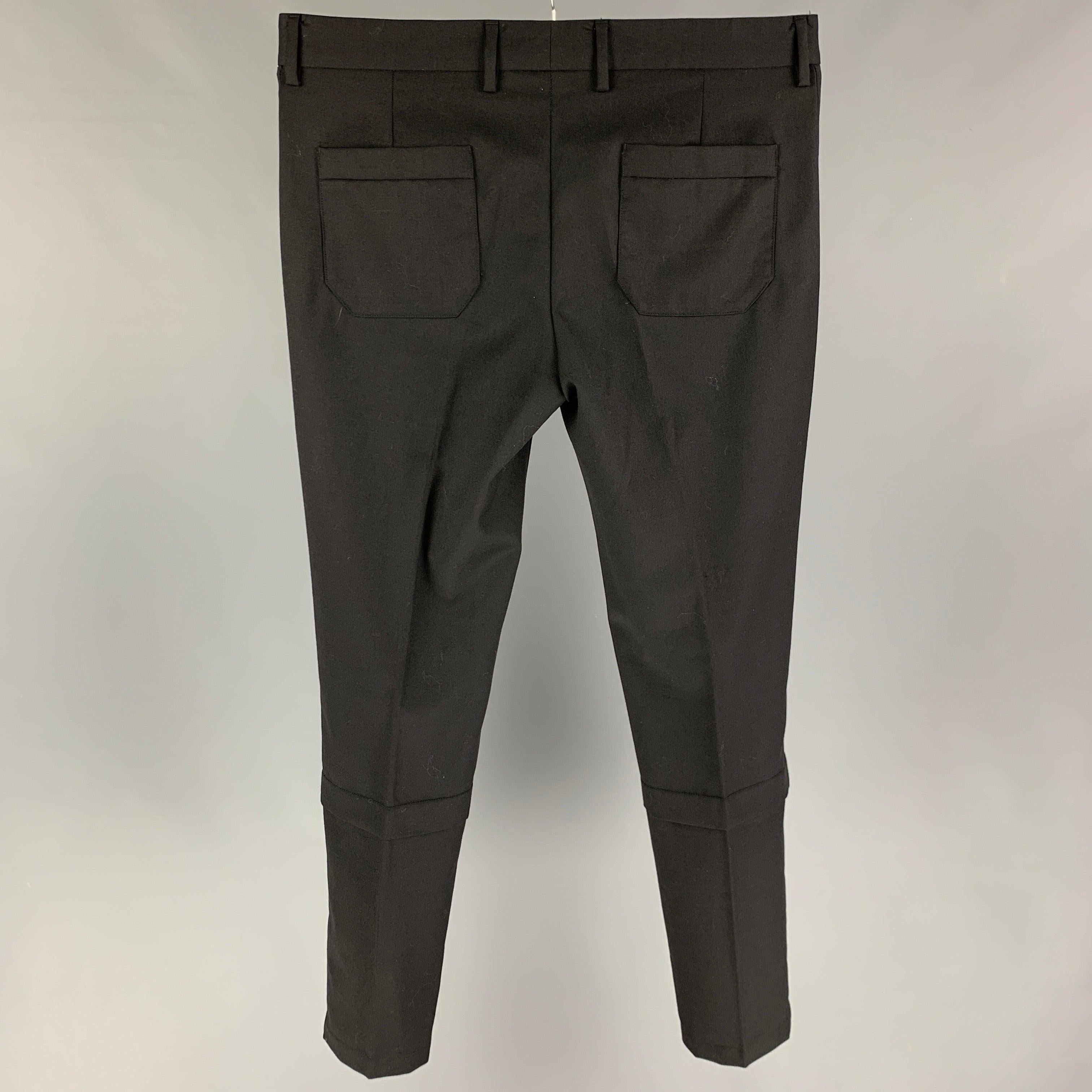 VIKTOR & ROLF pants comes in a black wool featuring a slim fit, front tab, and a zip fly closure. Made in Italy.
Very Good
Pre-Owned Condition. 

Marked:   50 

Measurements: 
  Waist: 34 inches  Rise: 9.5 inches  Inseam: 32 inches 
  
  
